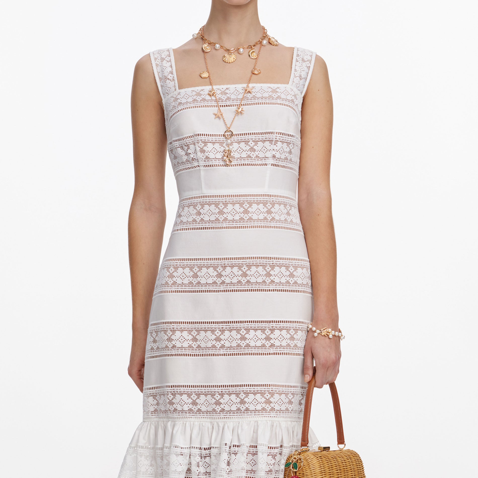 A close up of a woman wearing the White Cotton Embroidered Midi Dress