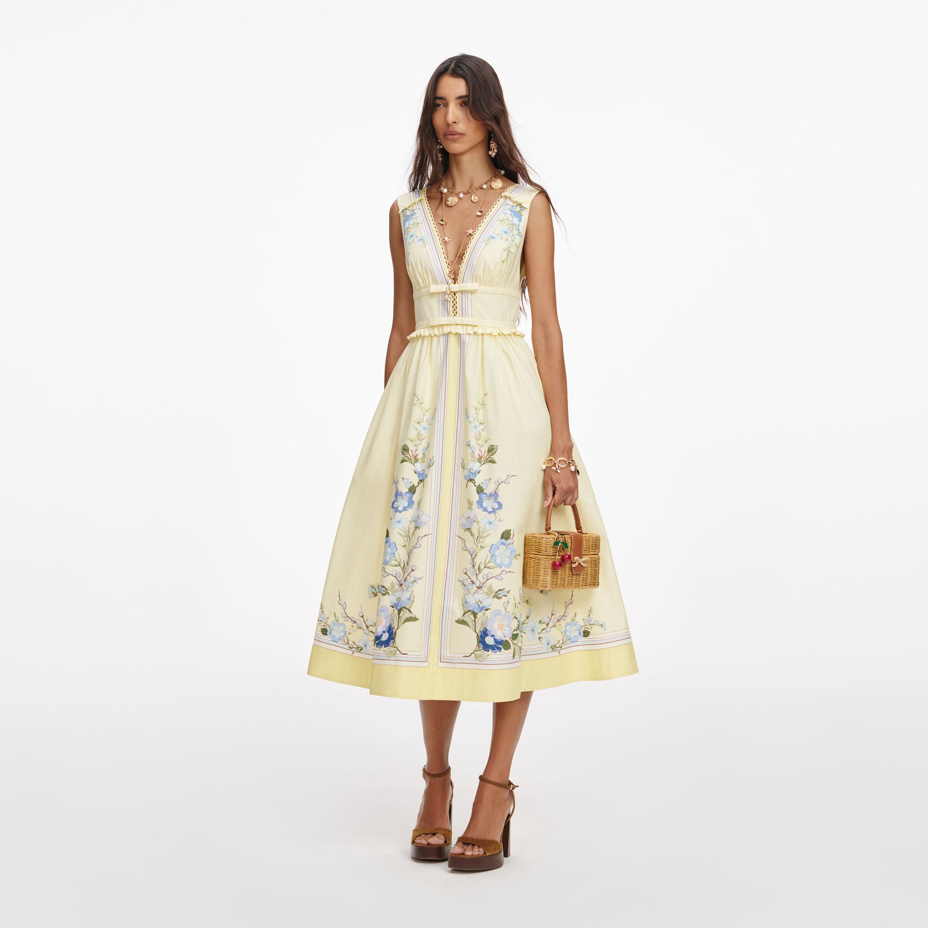 Side view of a woman wearing the Yellow Floral Cotton Midi Dress