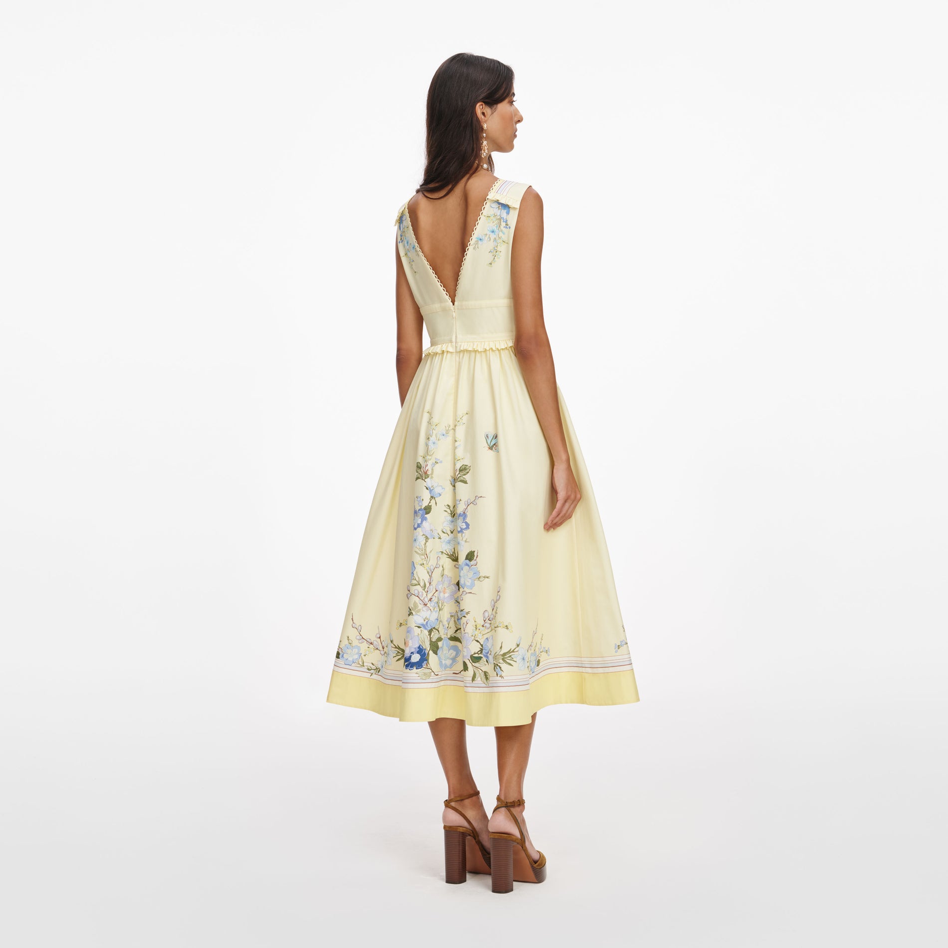 Back view of a woman wearing the Yellow Floral Cotton Midi Dress