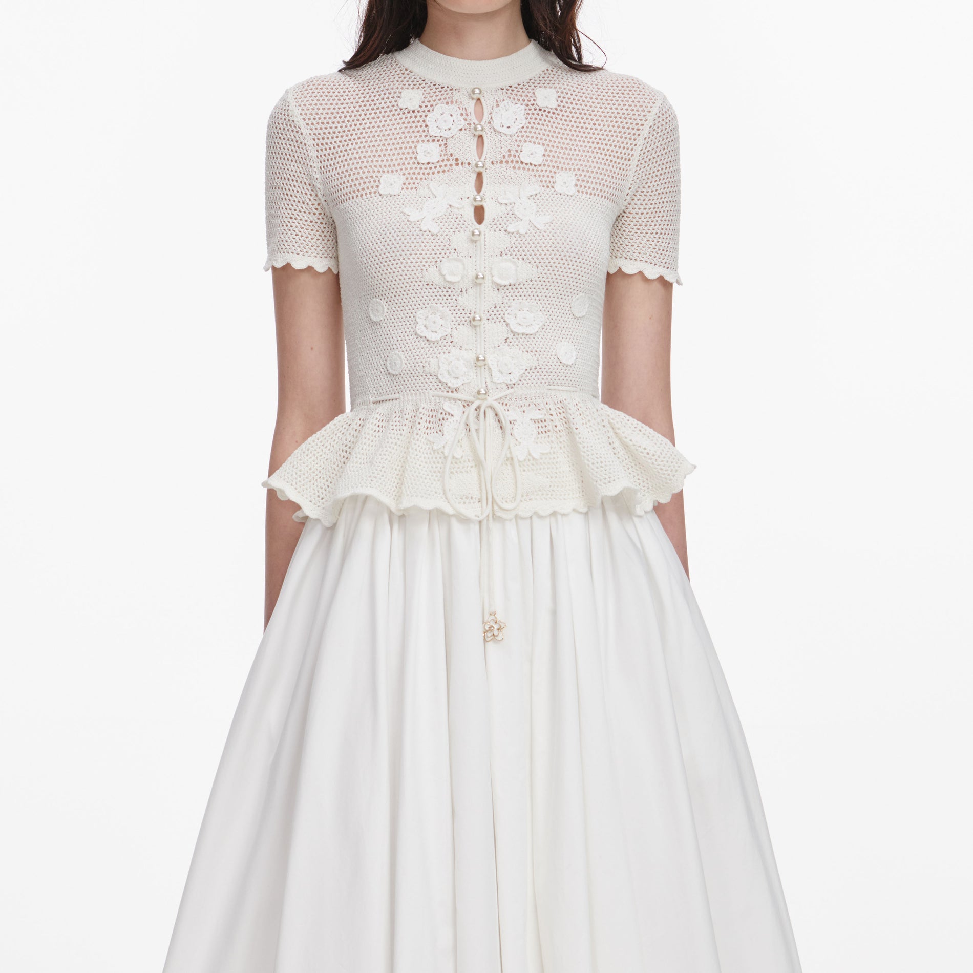 A close up of a woman wearing the White Floral Crochet Top