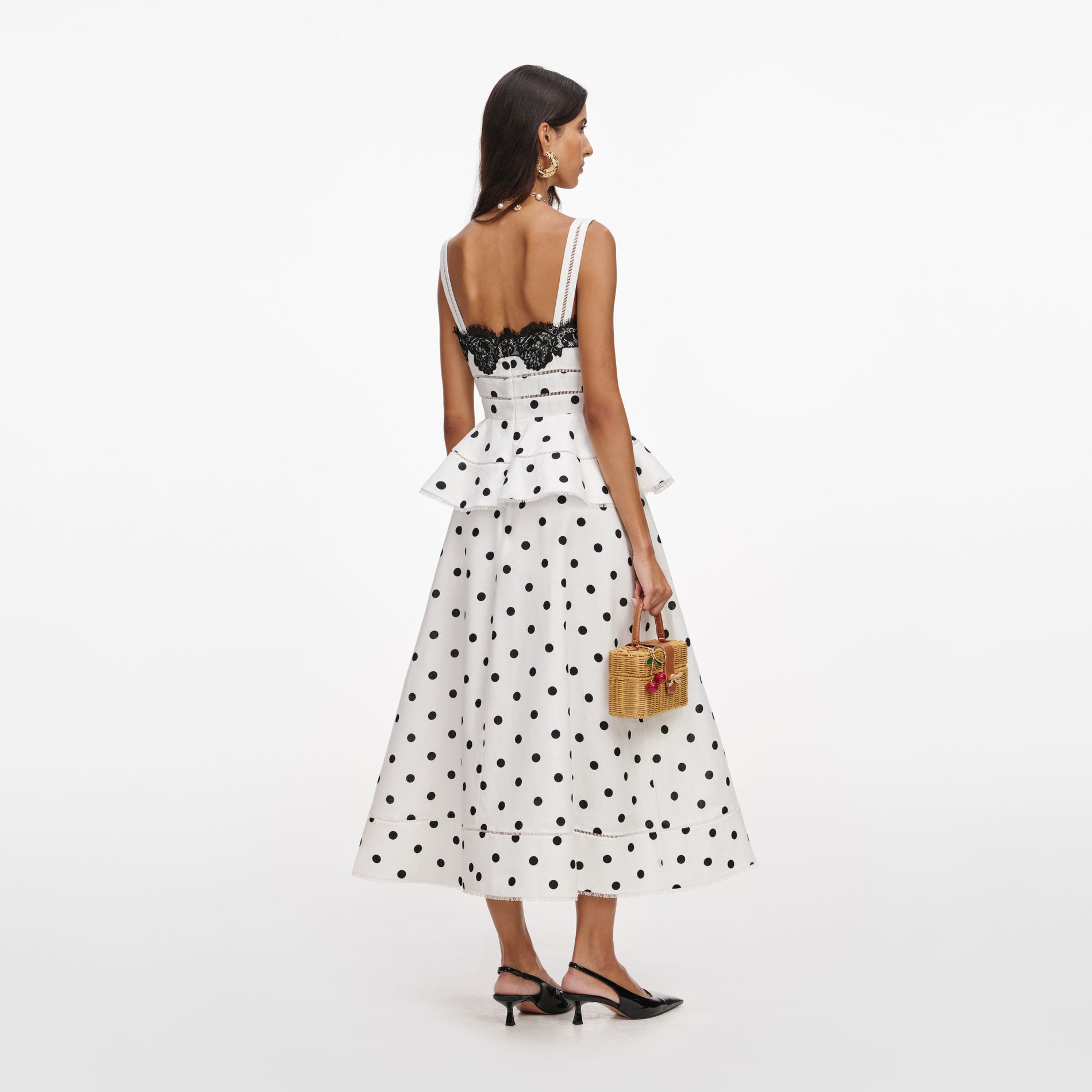 Back view of a woman wearing the White Polka Dot Linen Midi Dress