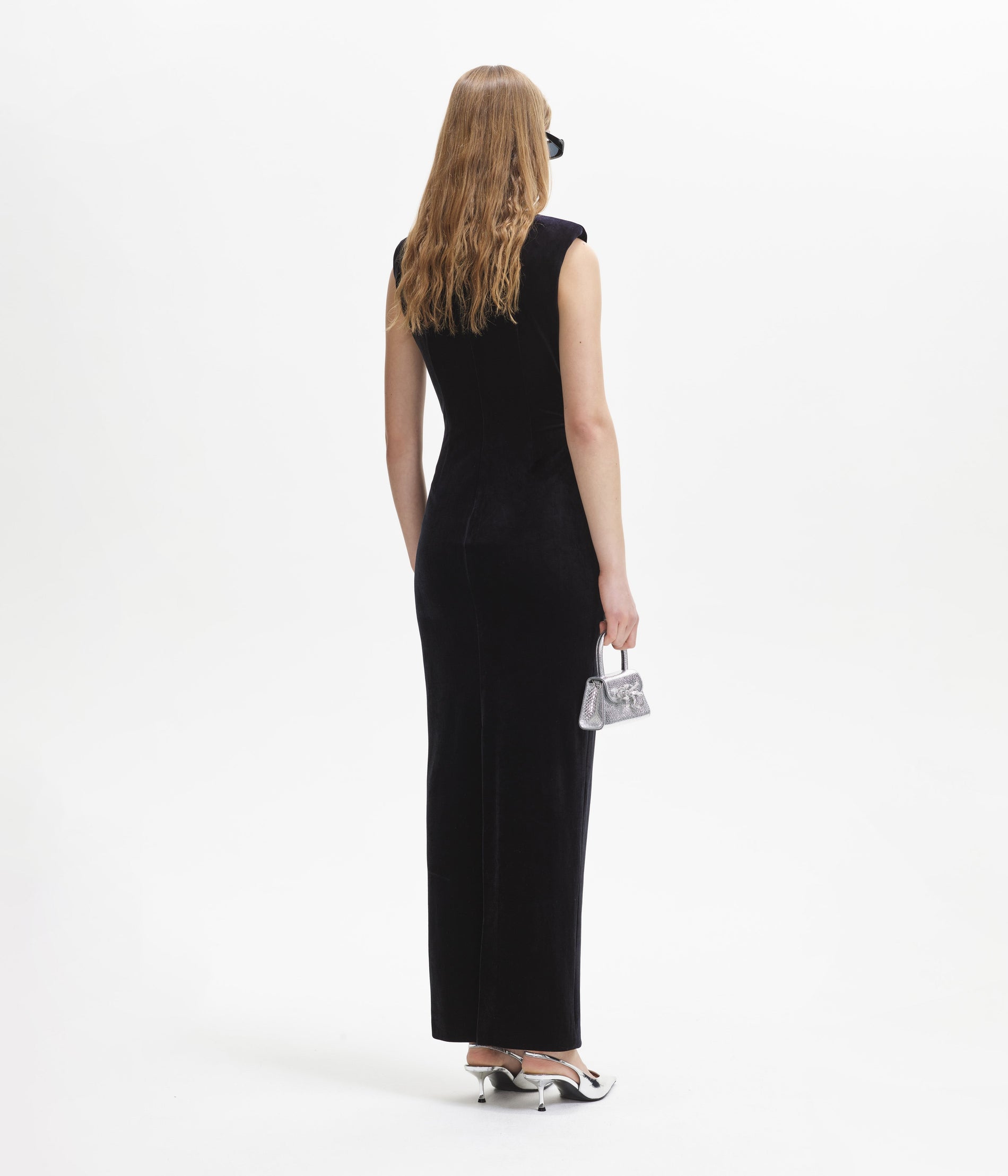 Back view of a woman wearing the Black Velvet Cut Out Maxi Dress