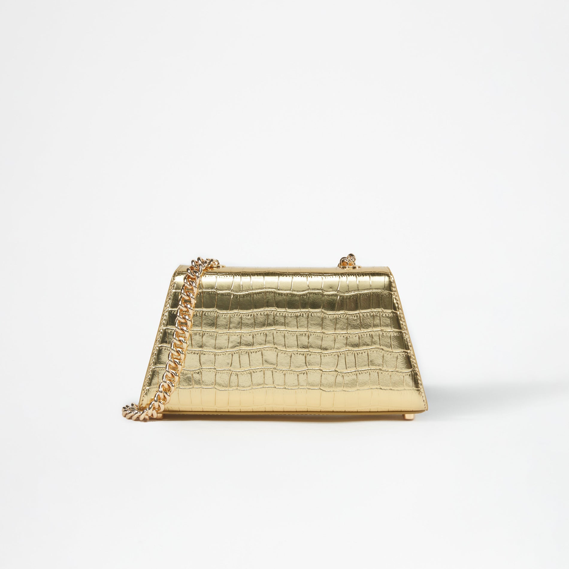 A woman wearing the Gold Metallic Bow Mini Shoulder Bag