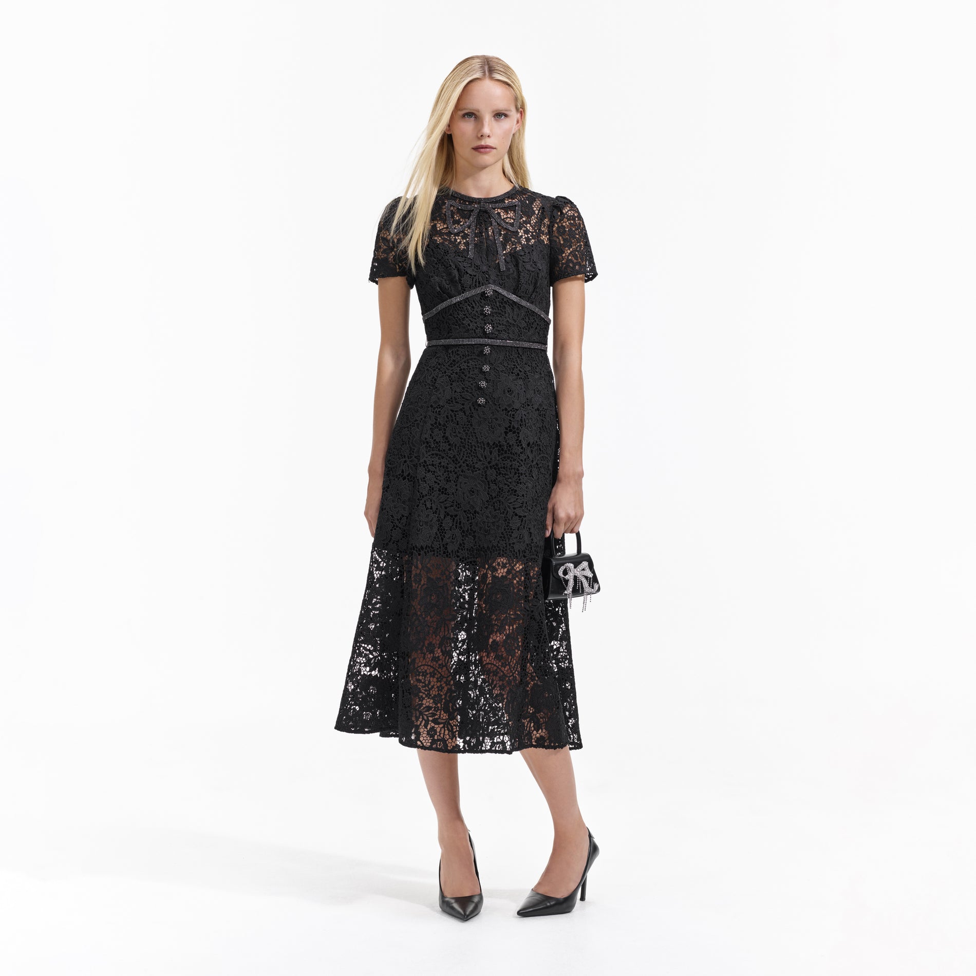 Front view of a woman wearing the Black Cord Lace Bow Midi Dress