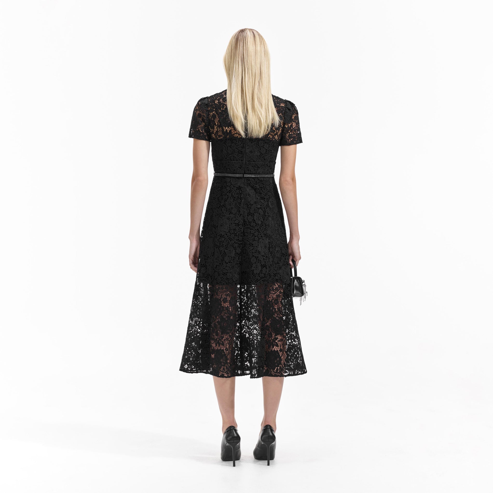 Back view of a woman wearing the Black Cord Lace Bow Midi Dress