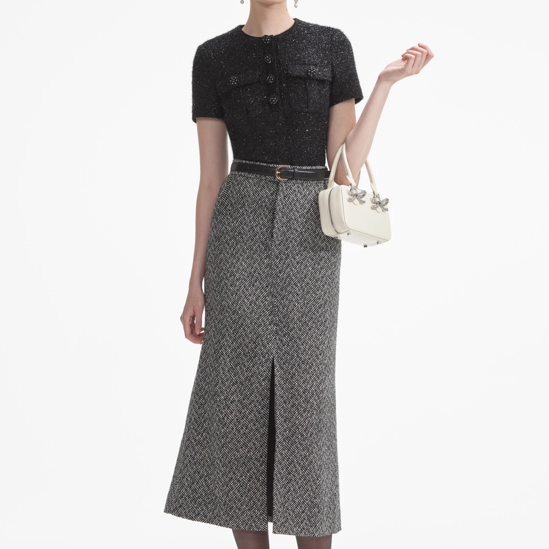 A close up of a woman wearing the Black Tinsel Boucle Top