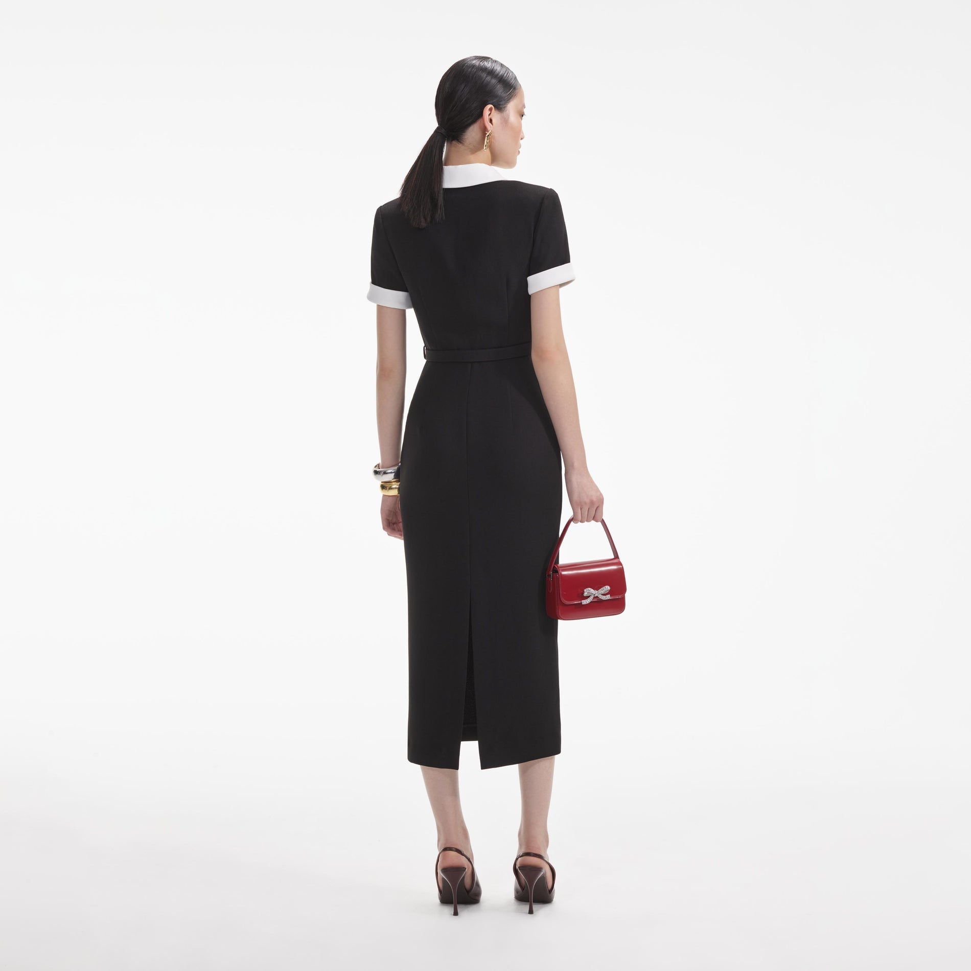 Back view of a woman wearing the White Black Crepe Contrast Midi Dress