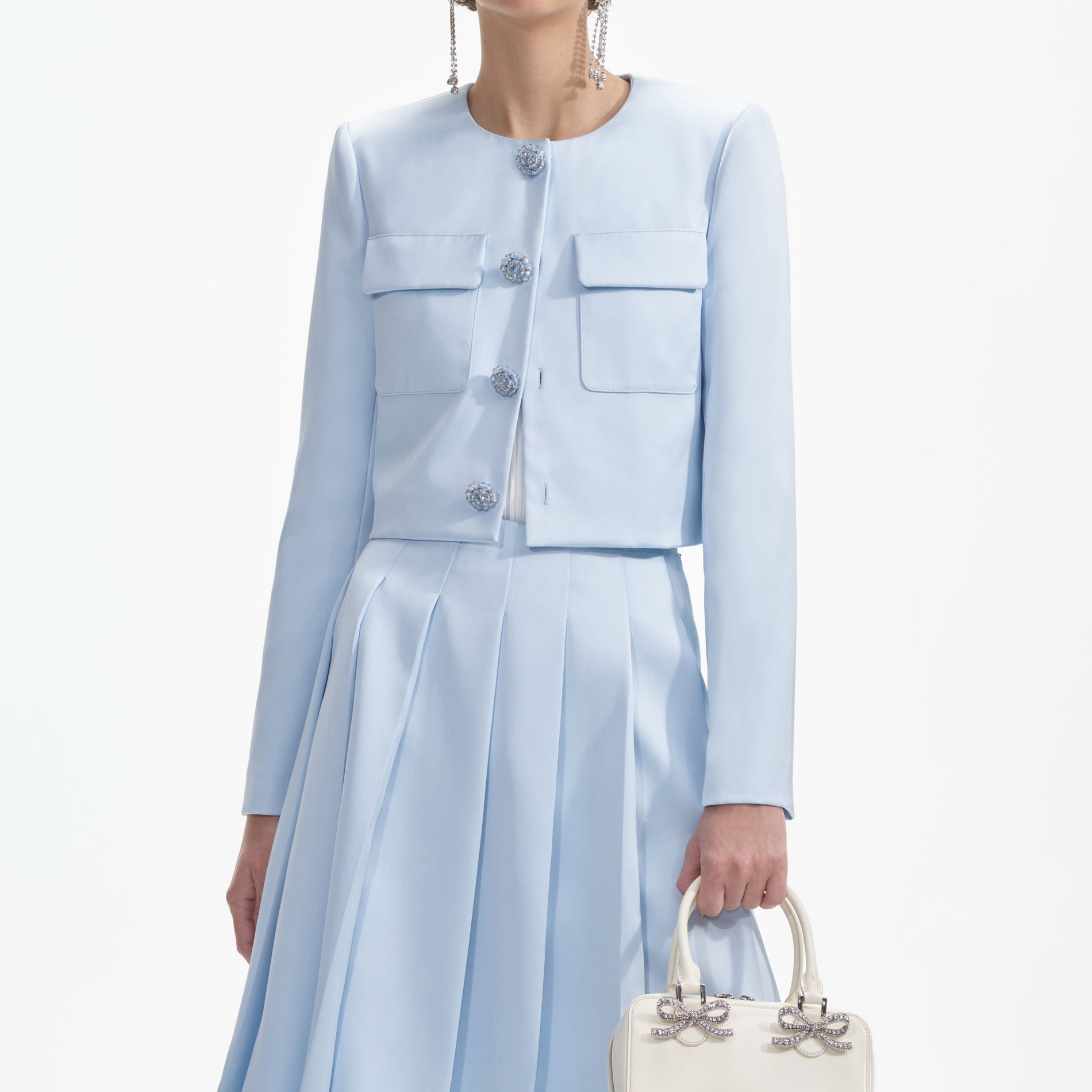 A close up of a woman wearing the Blue Satin Jacket