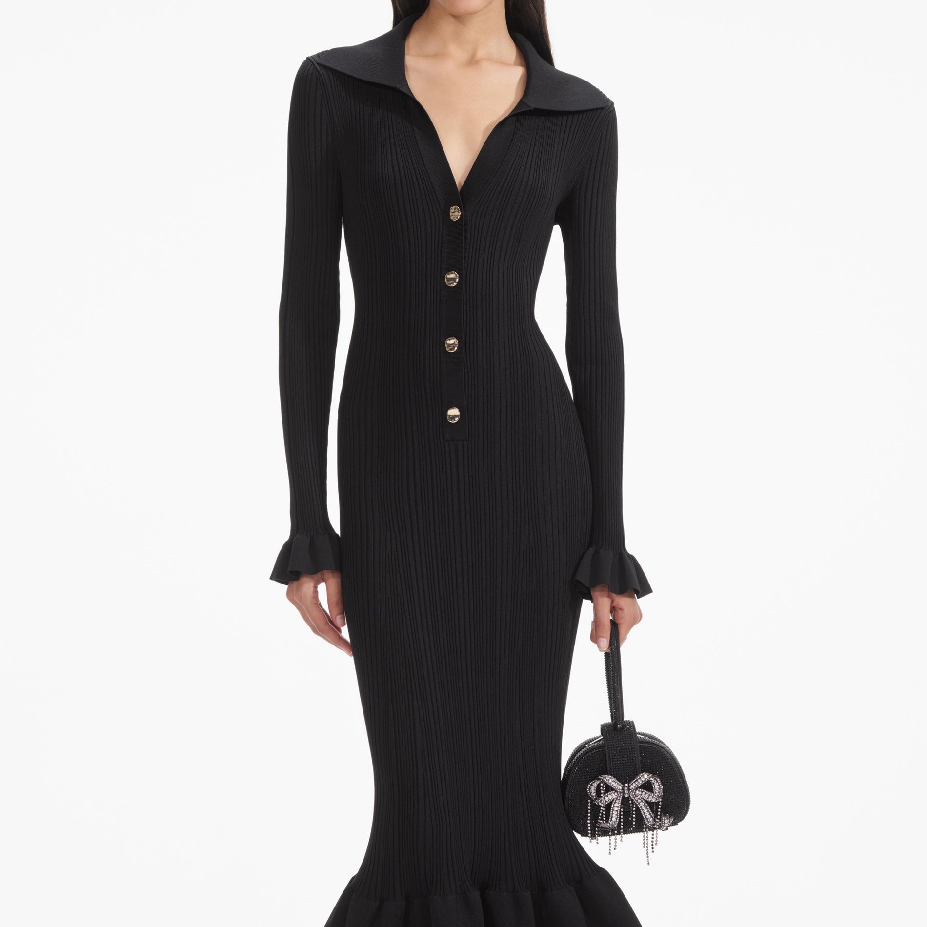 A close up of a woman wearing the Black Ribbed Knit Fluted Midi Dress