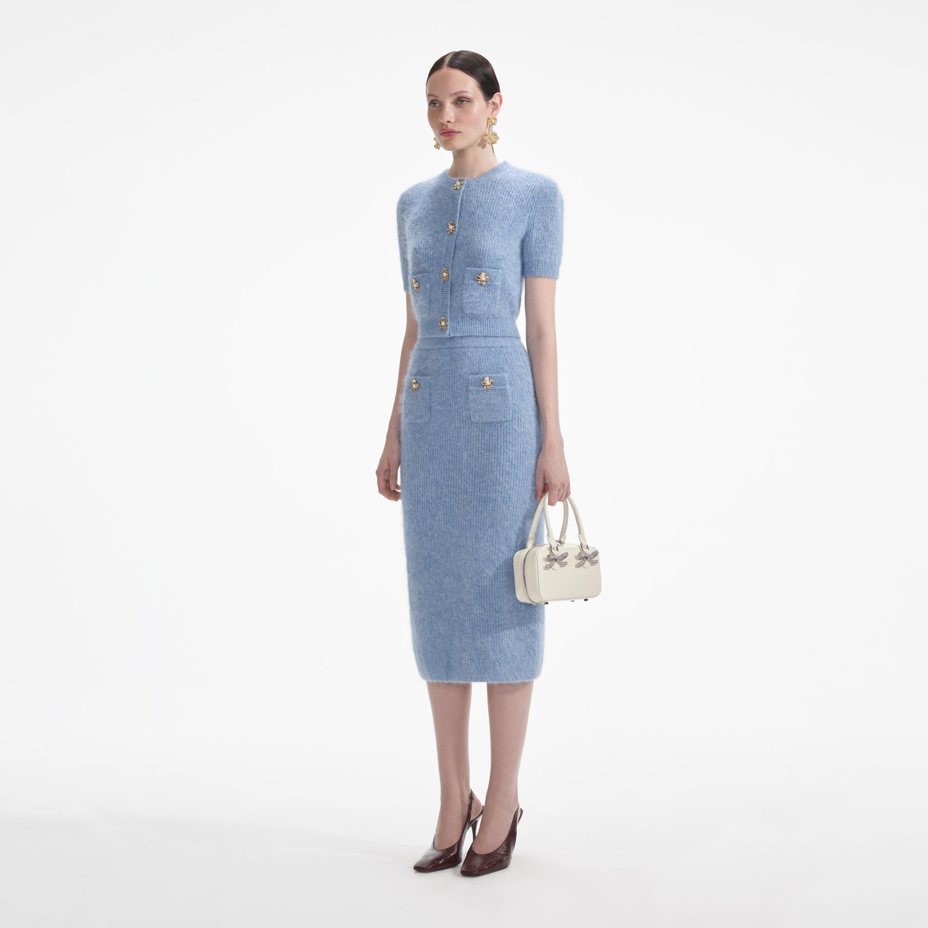 Side view of a woman wearing the Blue Soft Knit Midi Skirt