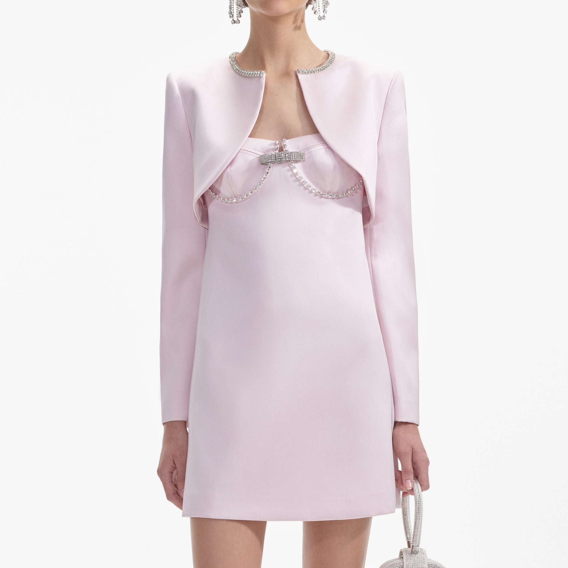 A close up of a woman wearing the Pink Satin Bolero Jacket