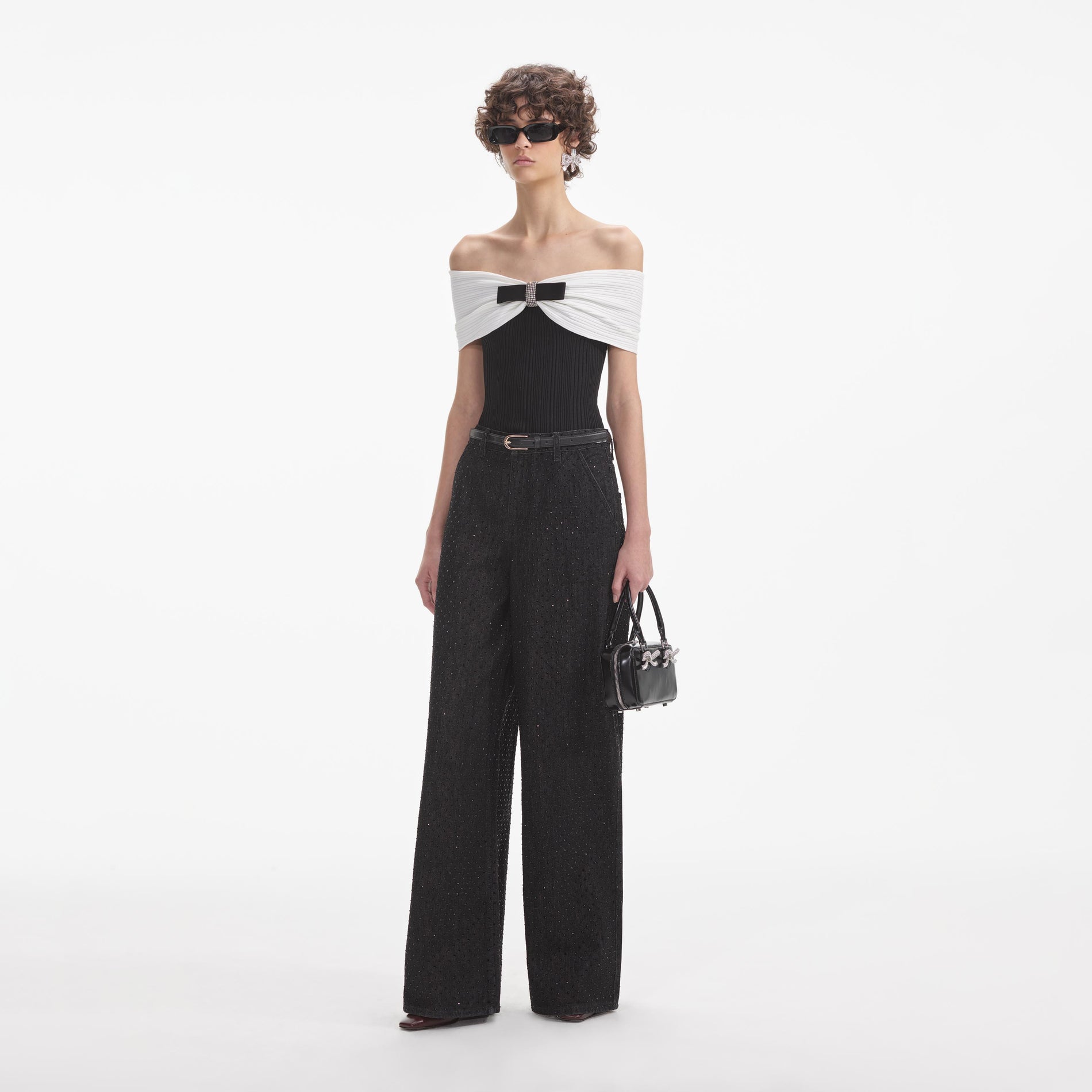 Side view of a woman wearing the Black Rhinestone Jeans