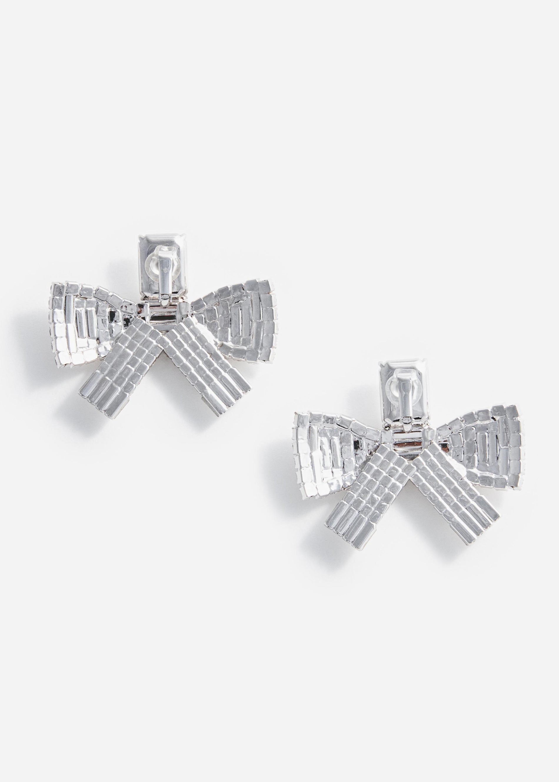 Pair of silver bow-shaped earrings with rhinestone embellishments
