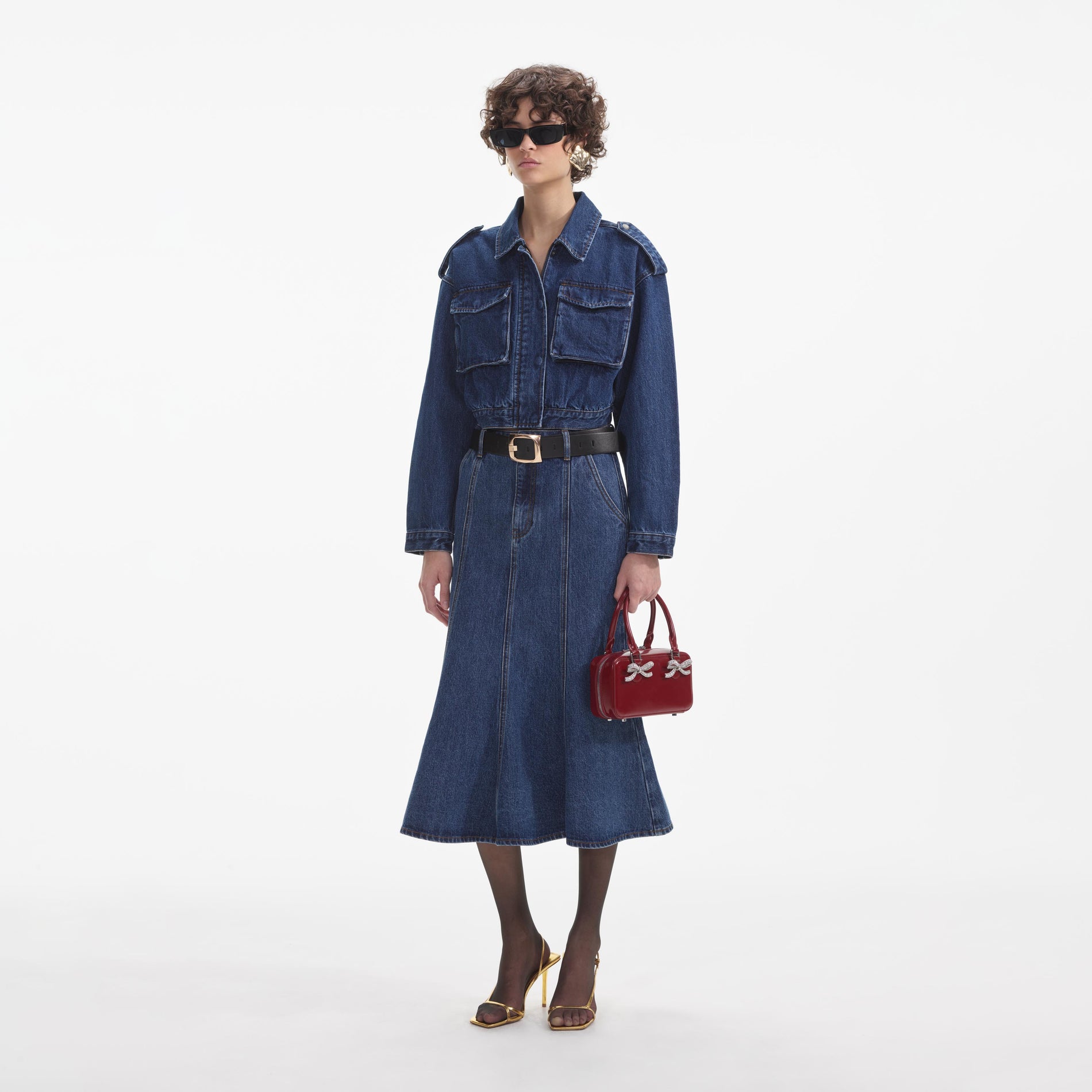 Side view of a woman wearing the Denim Utility Cropped Jacket