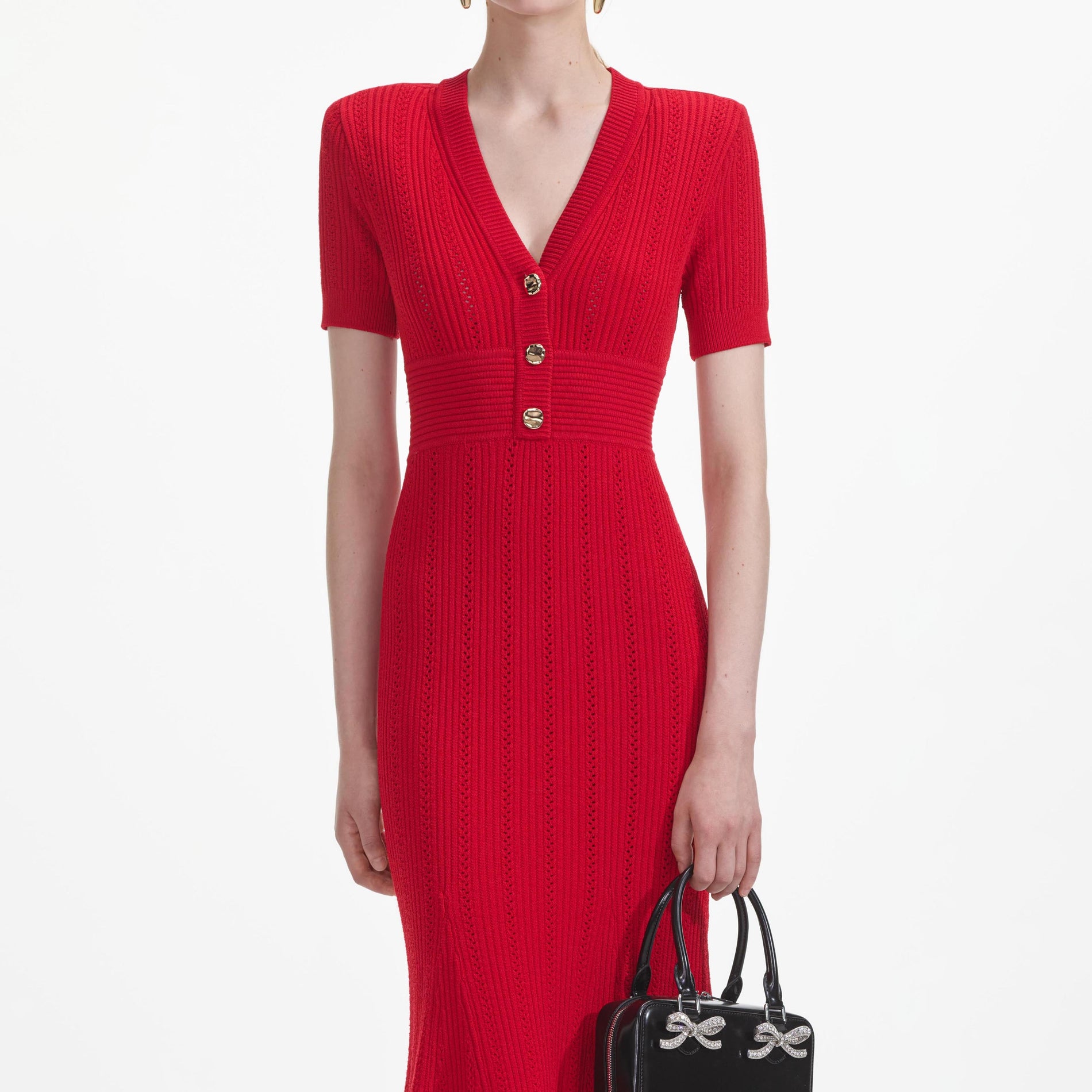 A close up of a woman wearing the Red Pointelle Knit Midi Dress