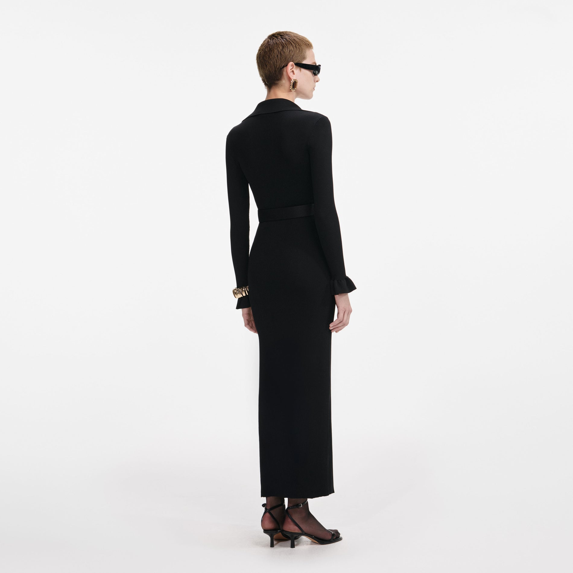 Back view of a woman wearing the Black Ribbed Knit Maxi Dress