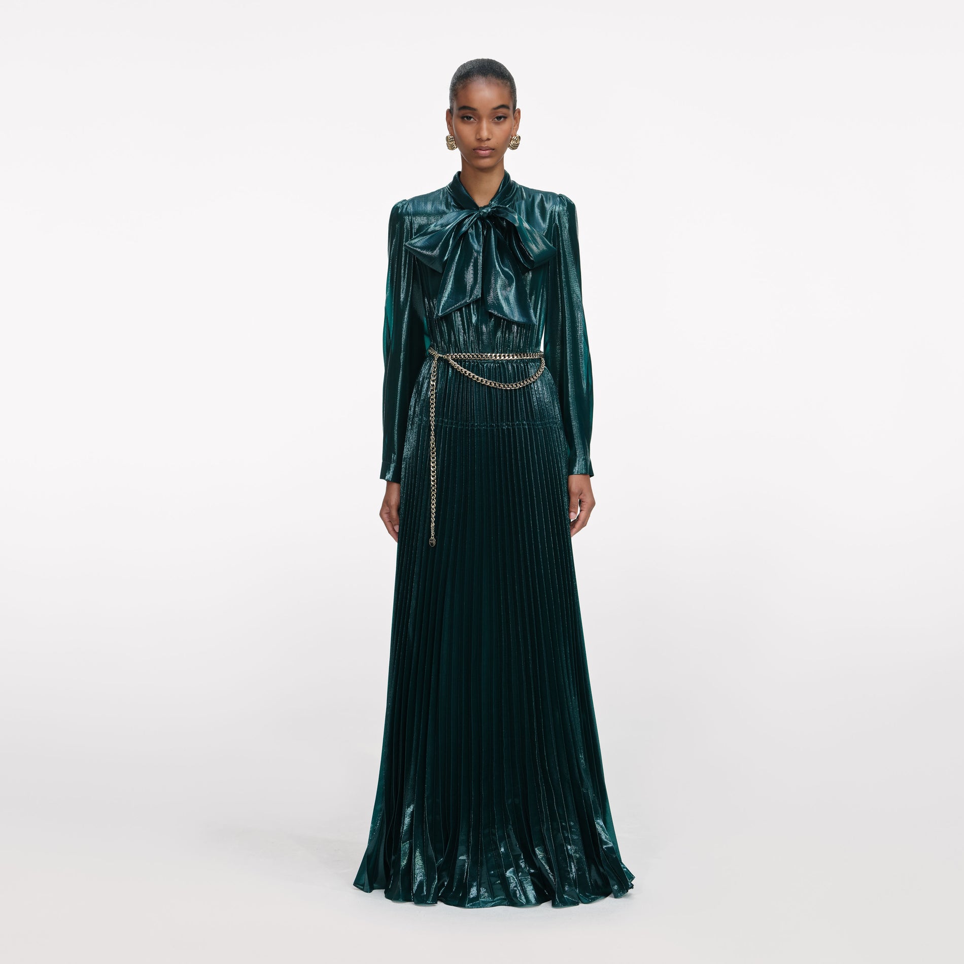 Front view of a woman wearing the Green Metallic Pussy Bow Maxi Dress