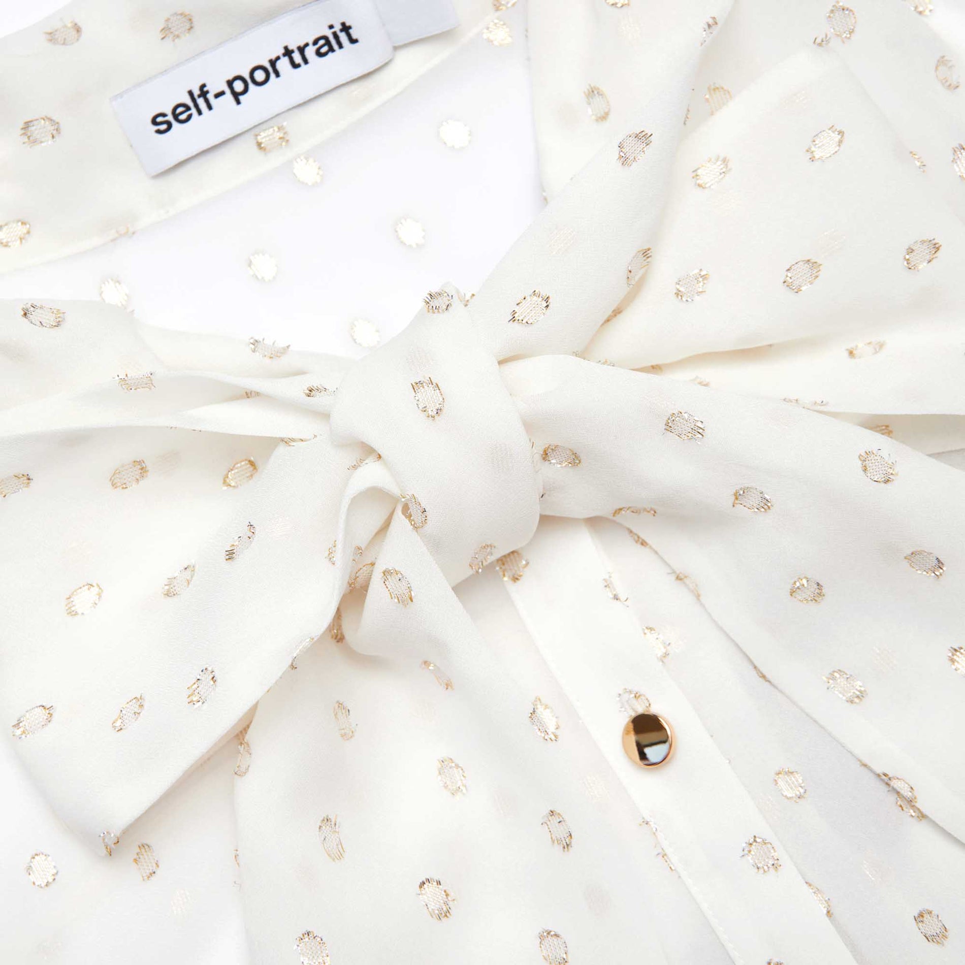 A close up of the fabric for the Cream And Gold Chiffon Blouse