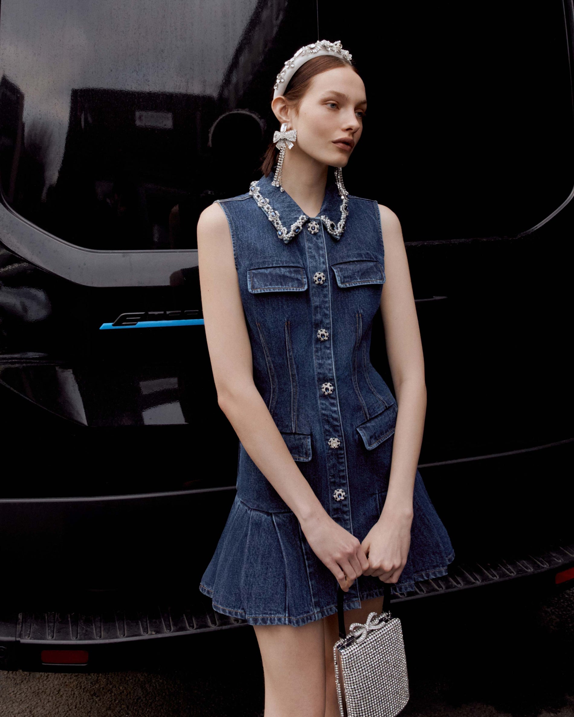 A close up of a woman wearing the Denim Sleeveless Mini Dress