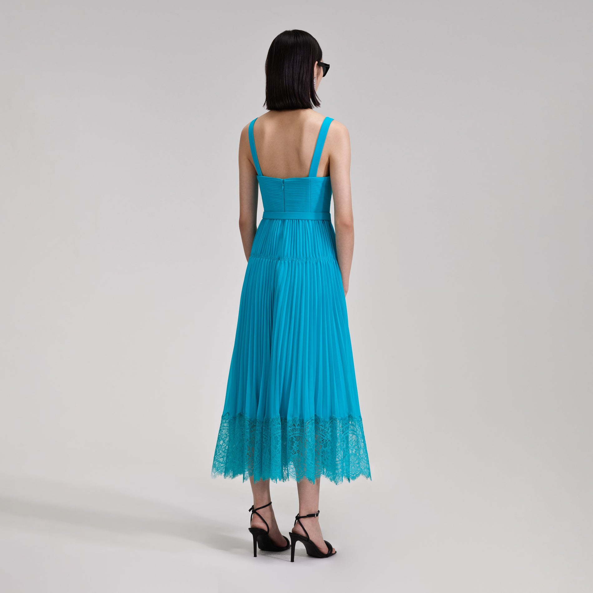 A woman wearing the Blue Chiffon Lace Midi Dress