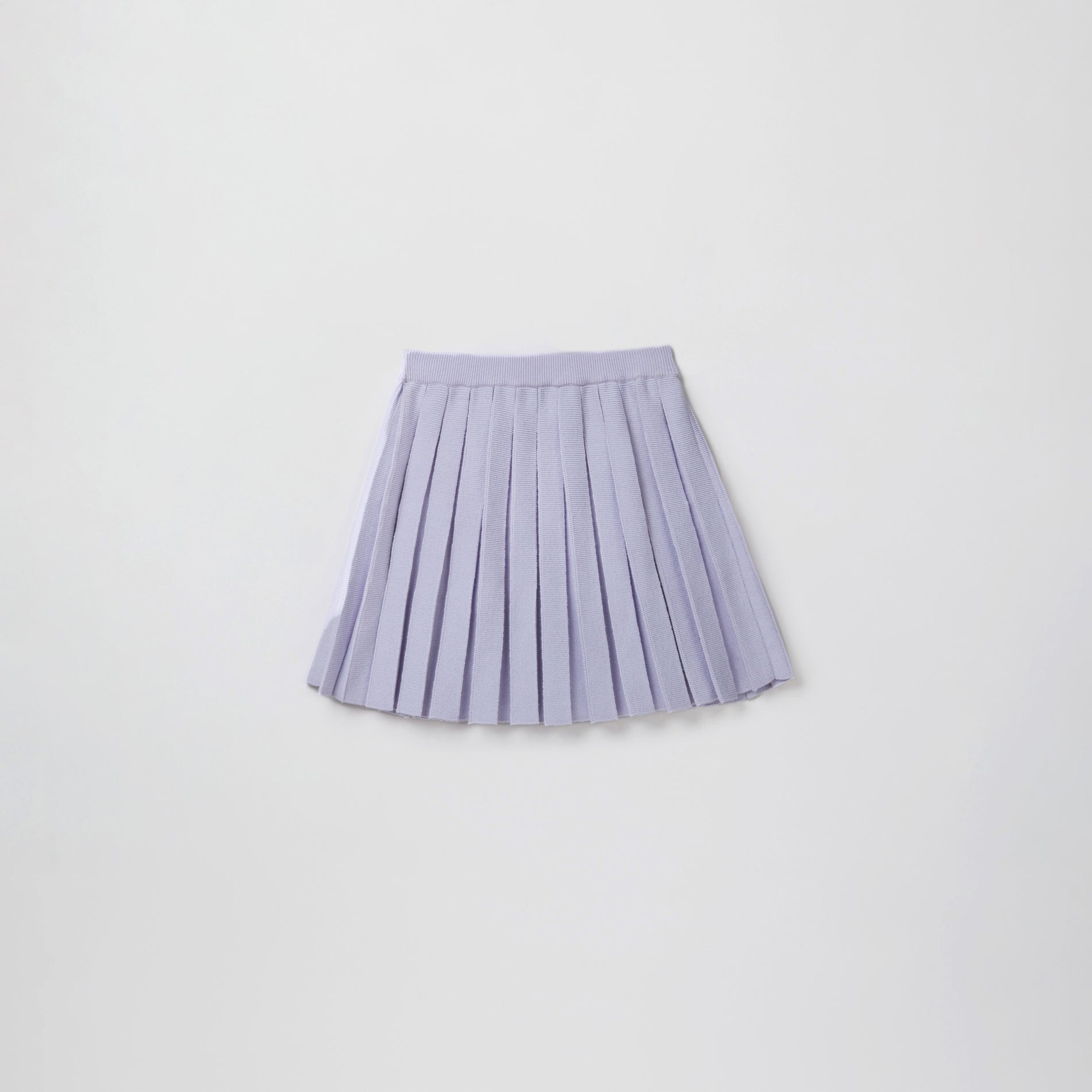 Side view of a woman wearing the Lilac Knit Pleated Skirt