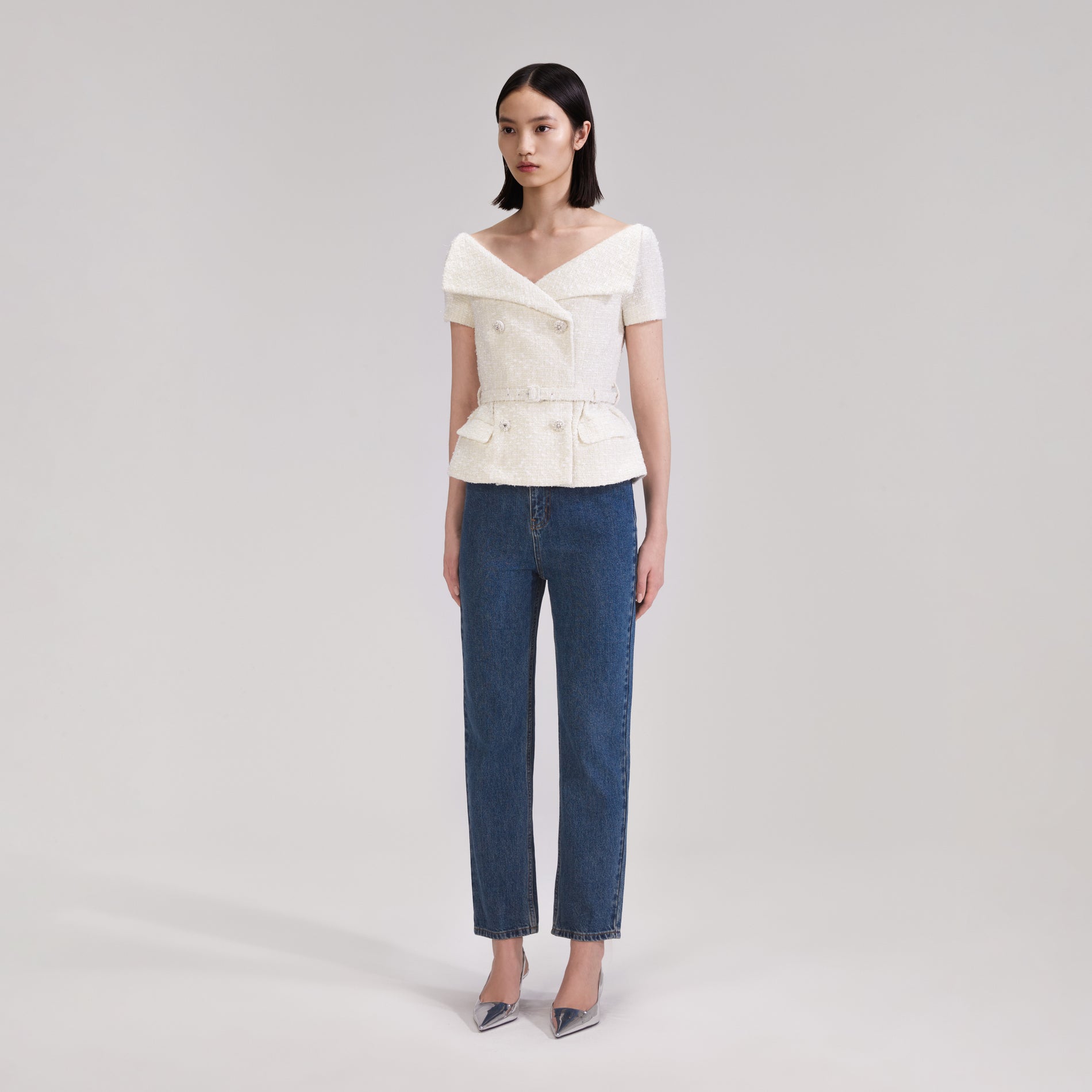 A woman wearing the Cream Off Shoulder Boucle Top