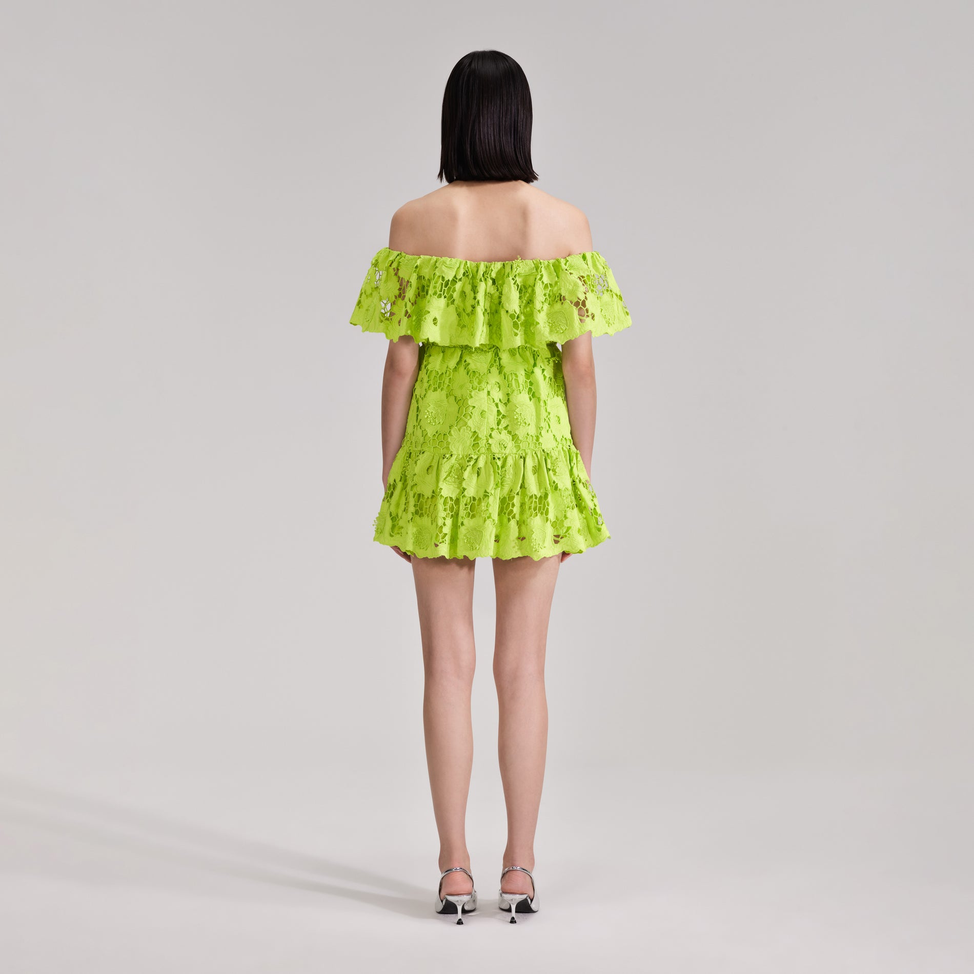 A woman wearing the Green Lace Off Shoulder Mini Dress