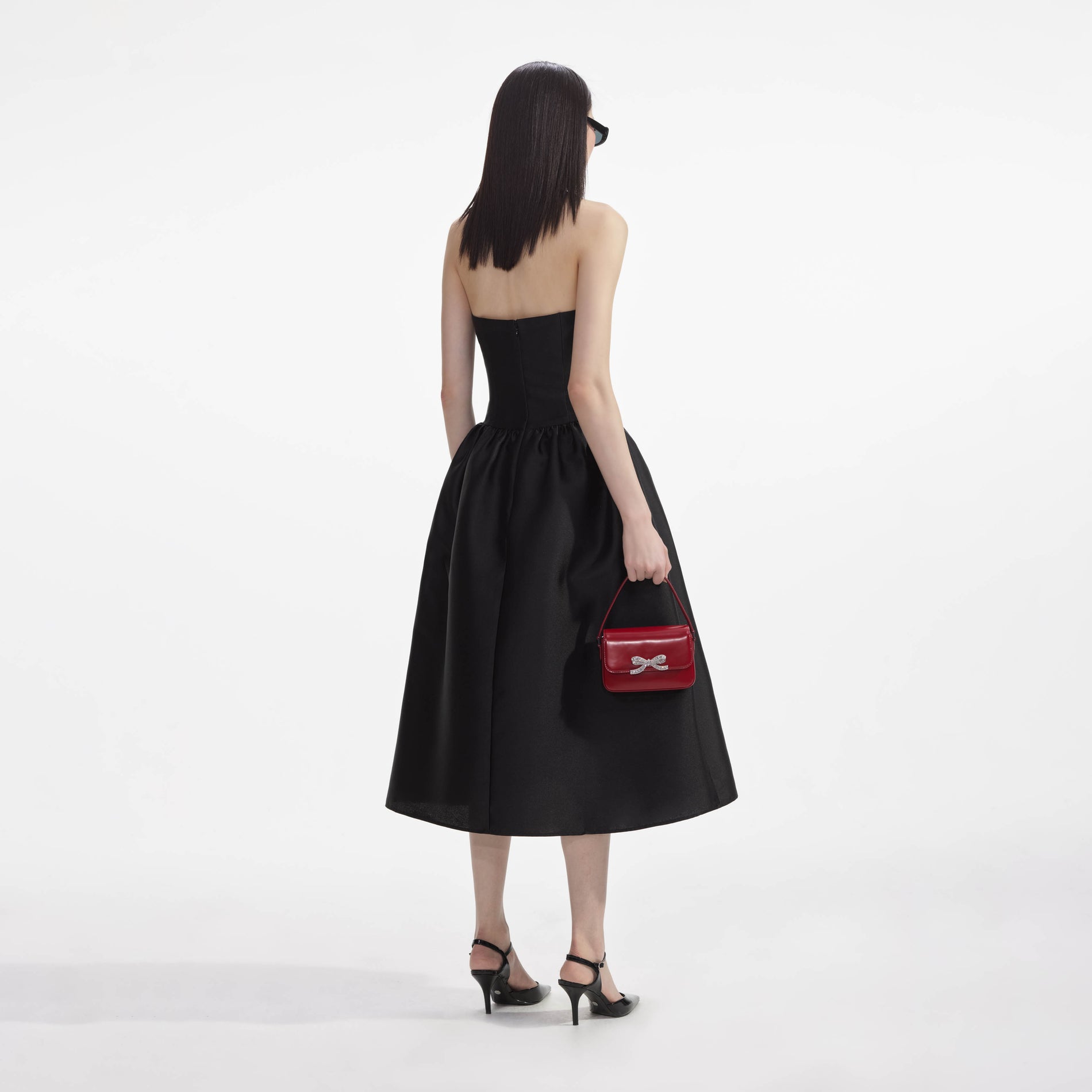 Back view of a woman wearing the Black Taffeta Midi Dress