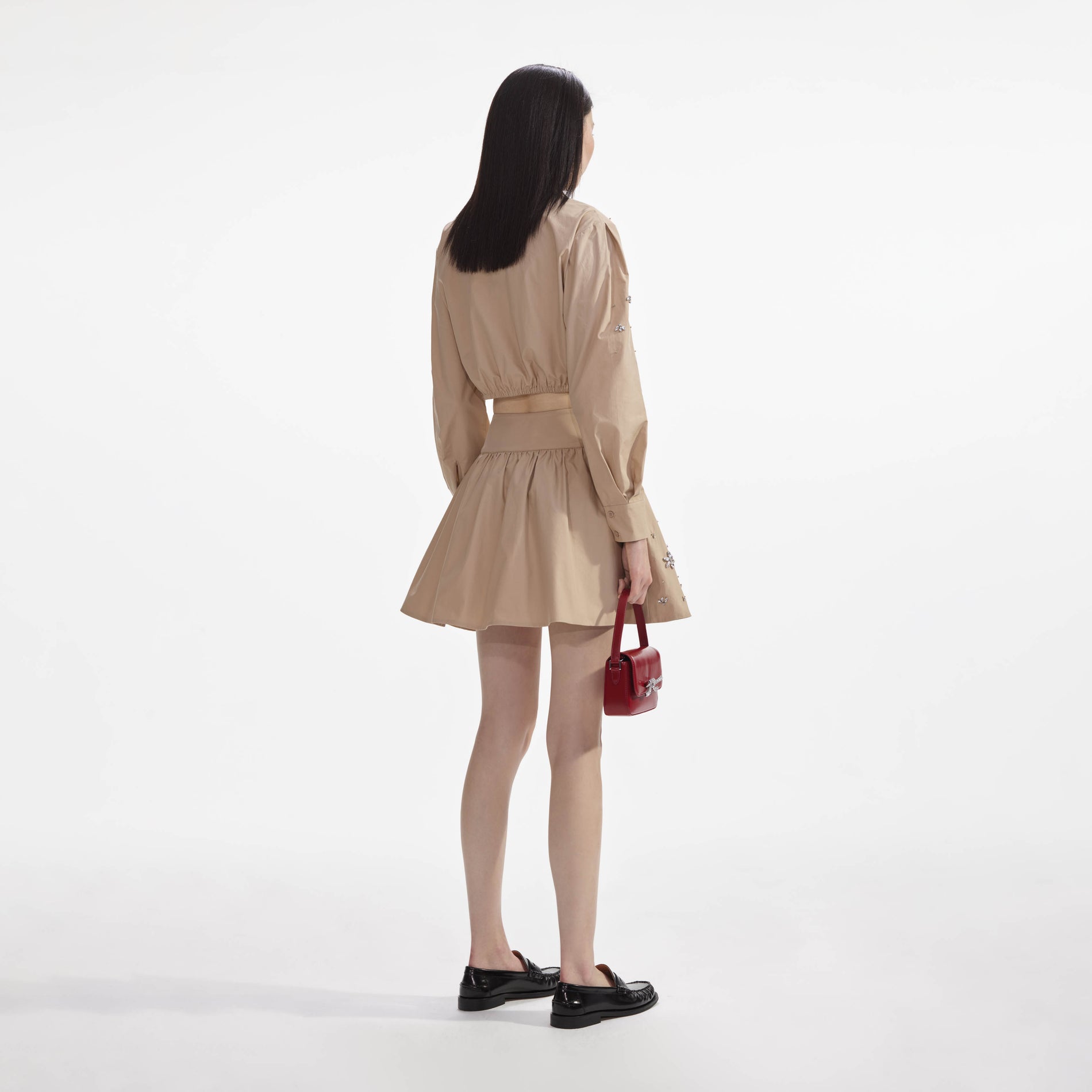 Back view of a woman wearing the Beige Cotton Embellished Top