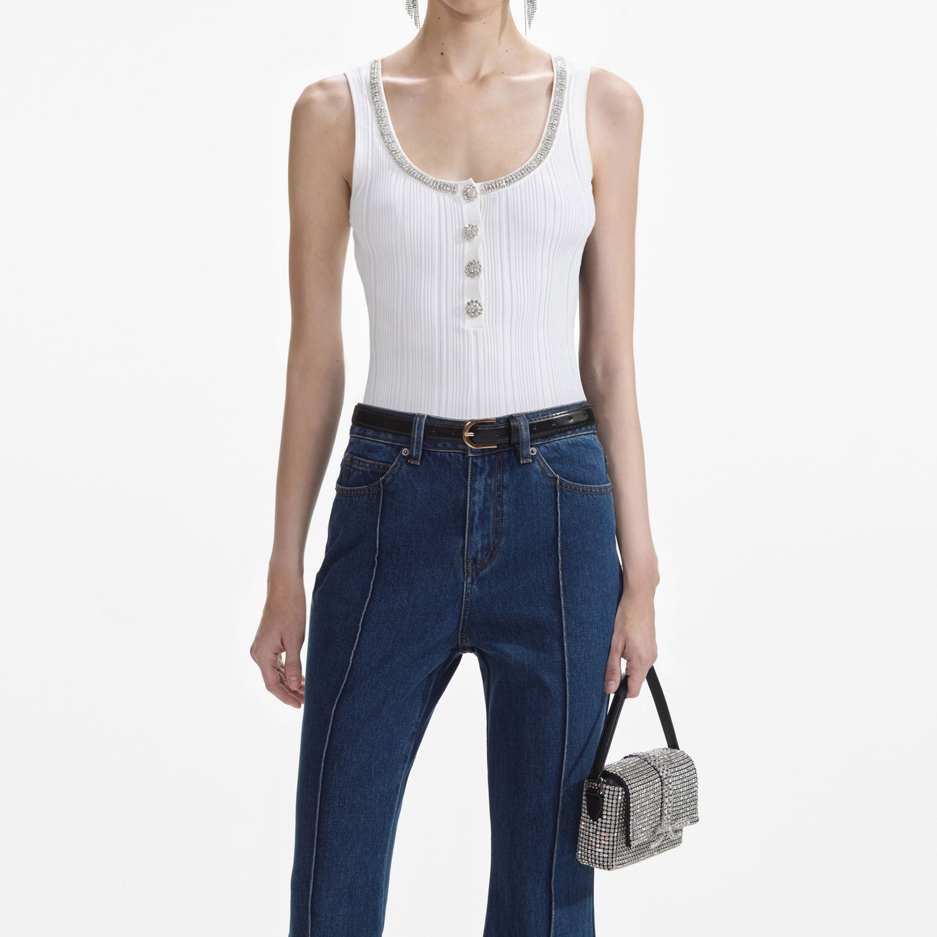 A close up of a woman wearing the White Ribbed Knit Top