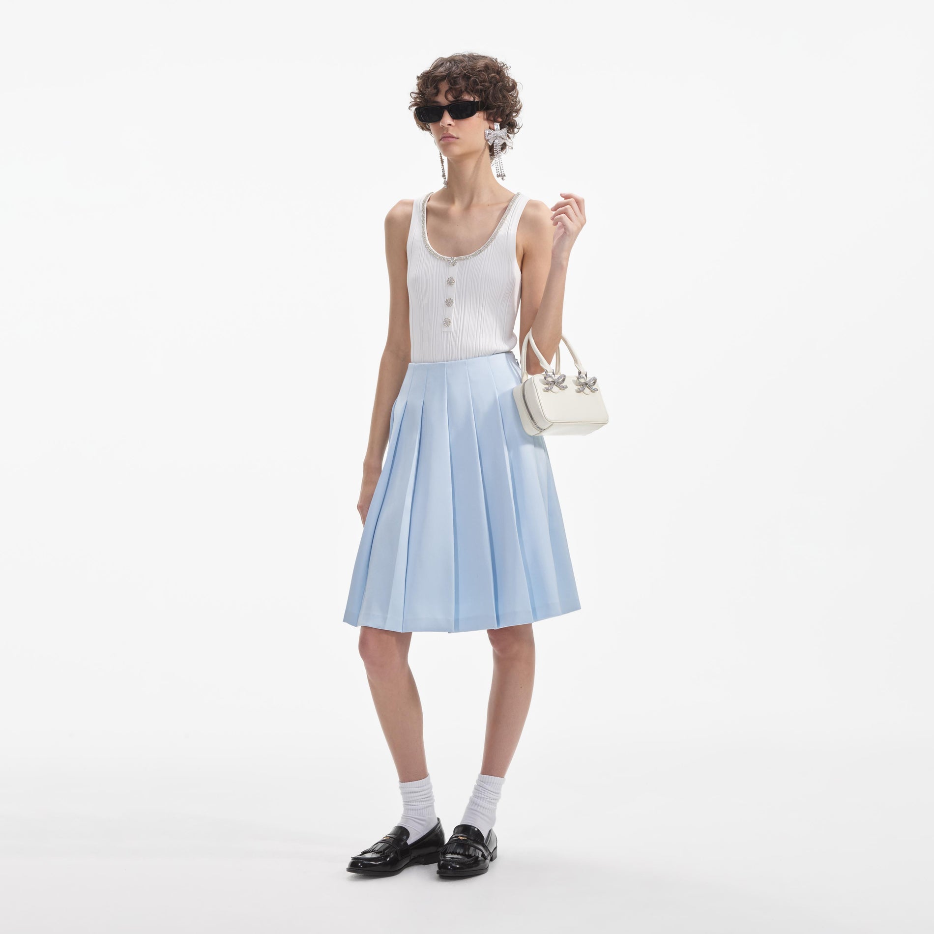 Side view of a woman wearing the Blue Satin Midi Skirt