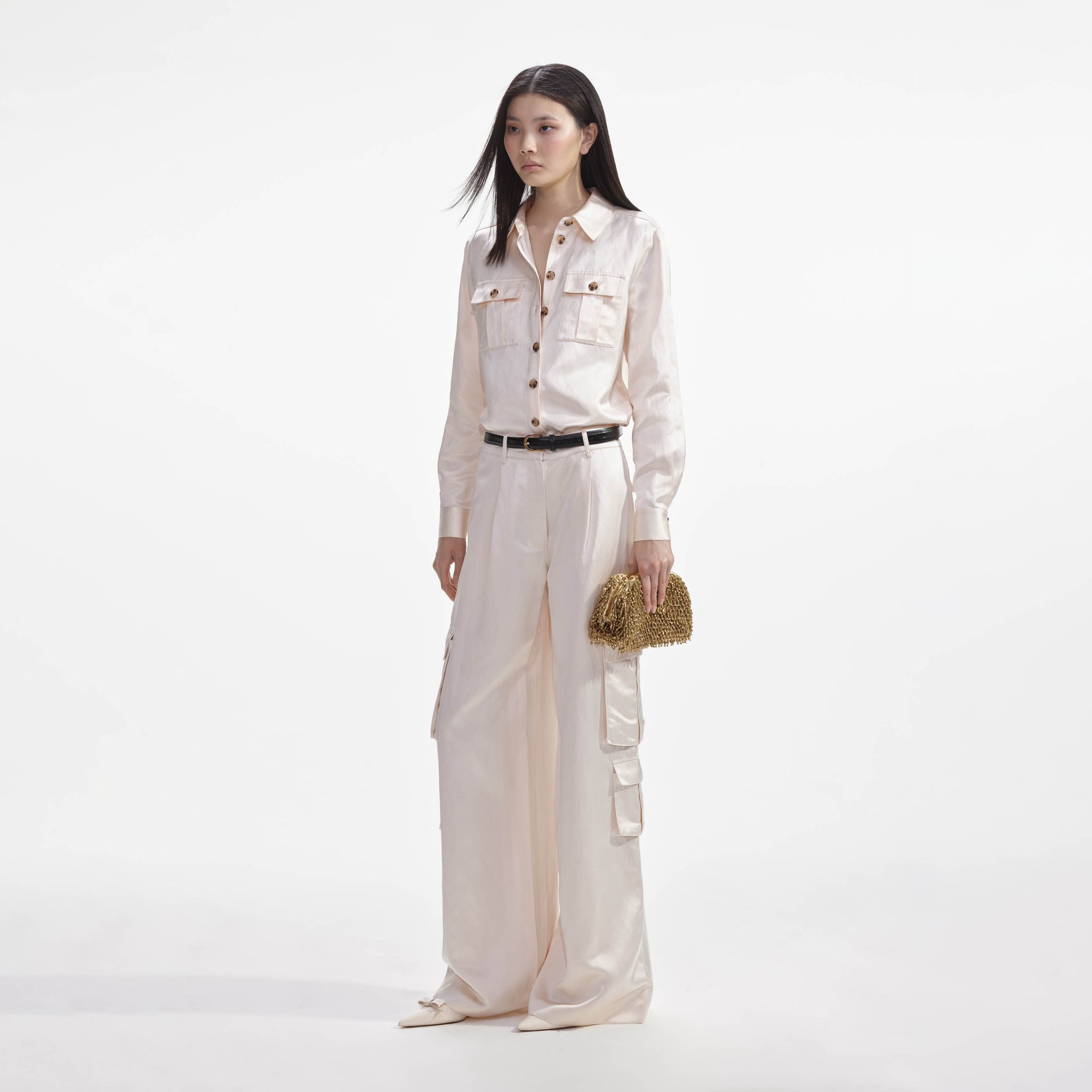 Side view of a woman wearing the Cream Satin Shirt
