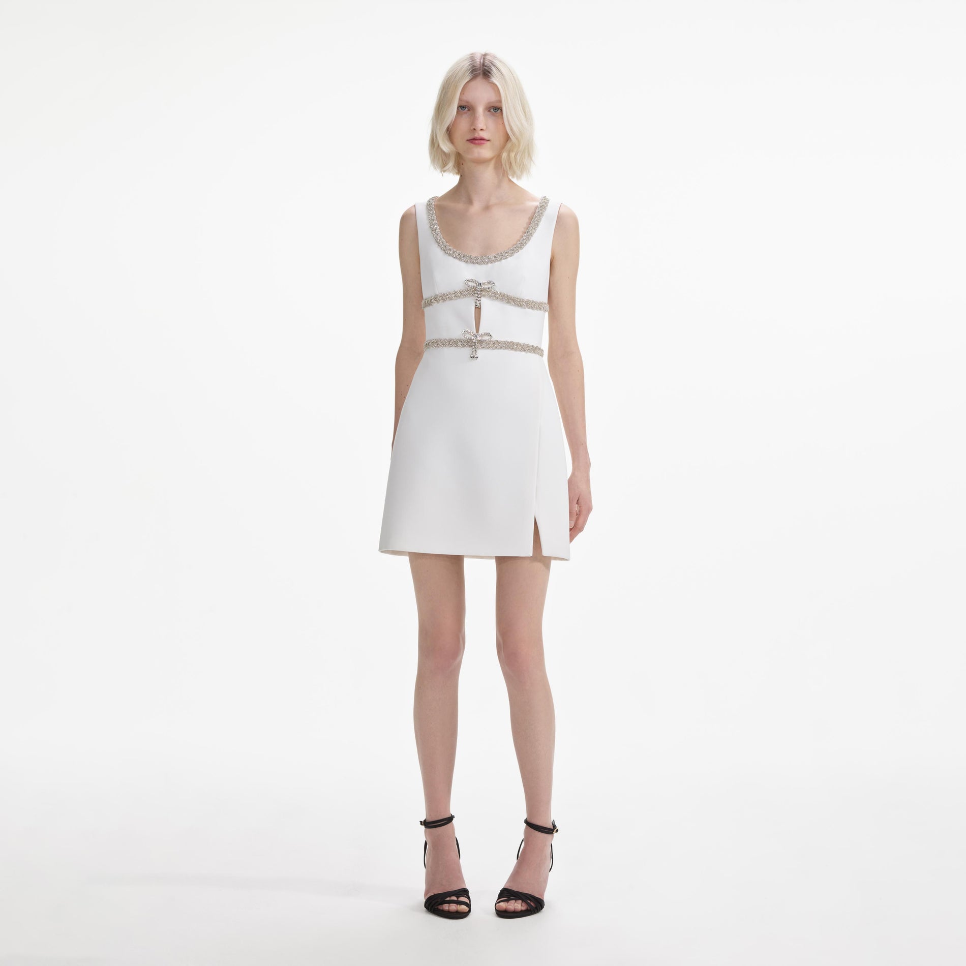 Front view of a woman wearing the White Diamante Bow Trim Mini Dress