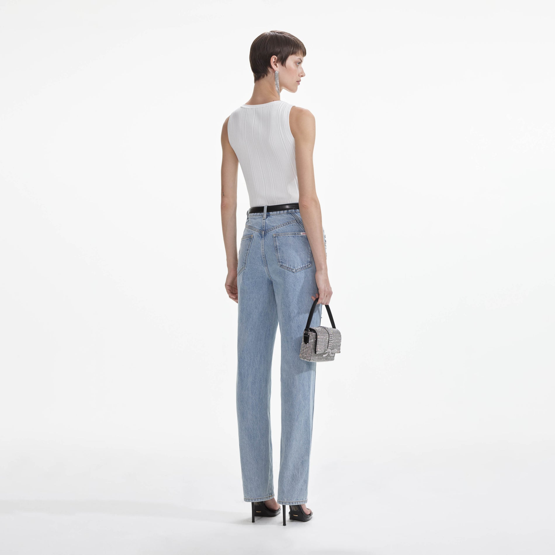 Back view of a woman wearing the Crystal Embellished Denim Jeans