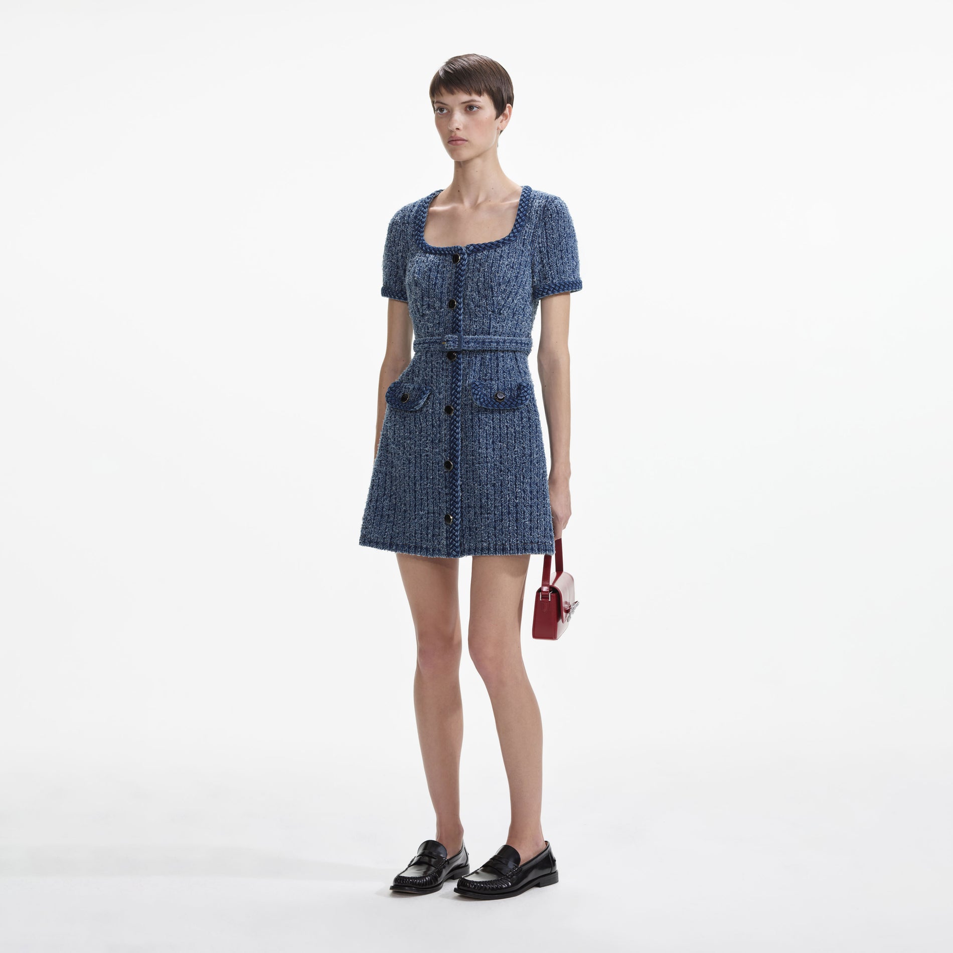 Side view of a woman wearing the Textured Denim Short Sleeve Mini Dress
