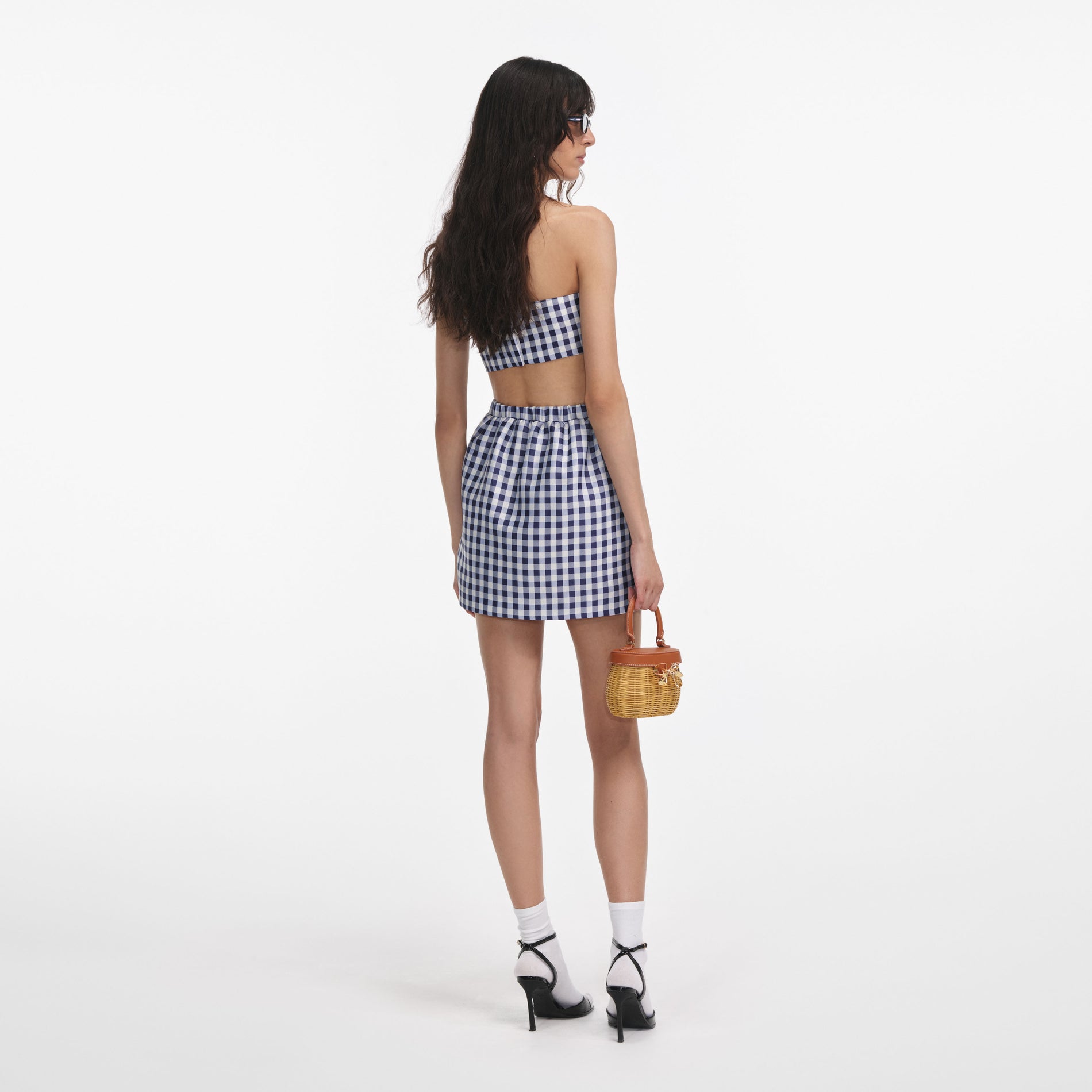 Back view of a woman wearing the Navy Gingham Taffeta Mini Skirt