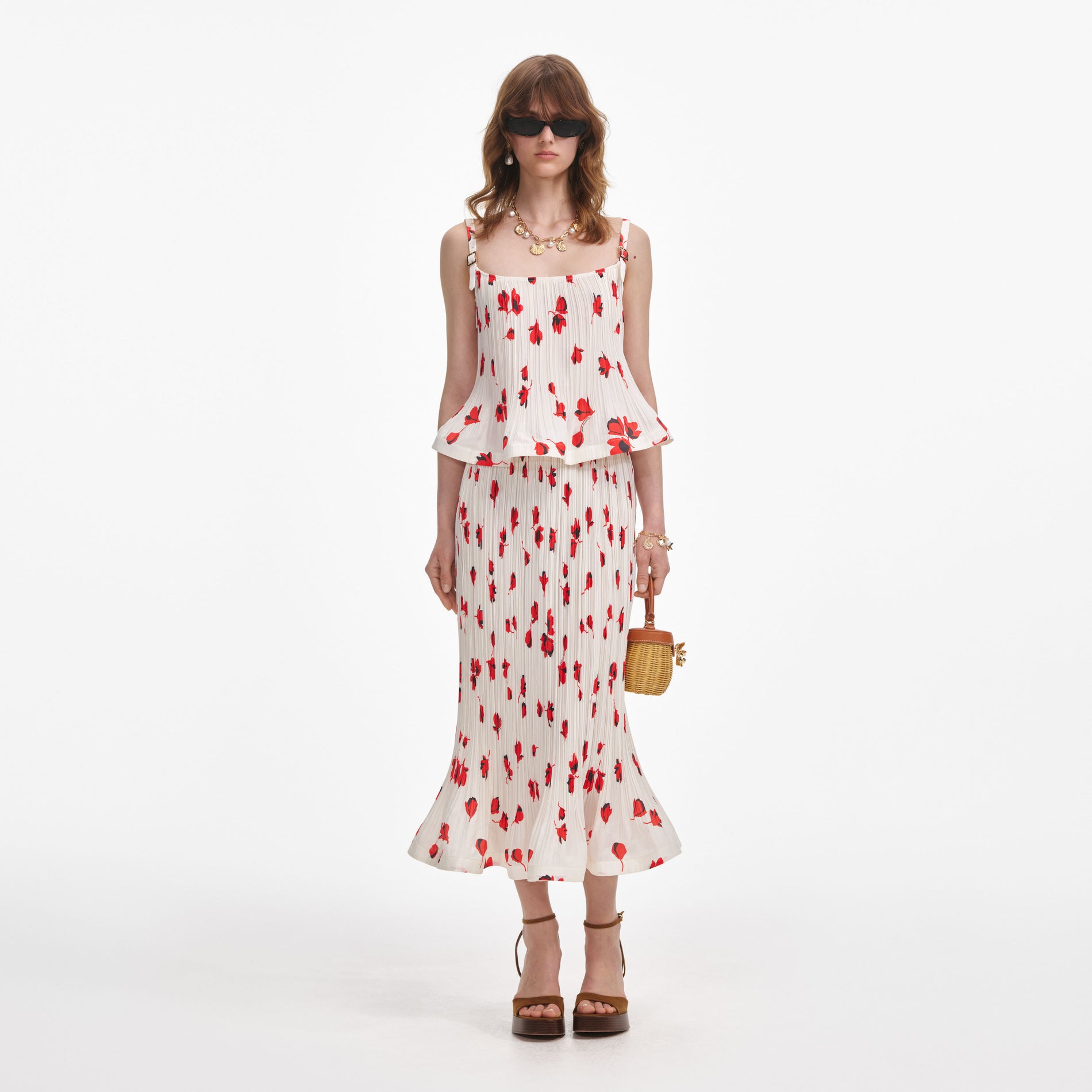 Front view of a woman wearing the White Floral Plisse  Midi Skirt