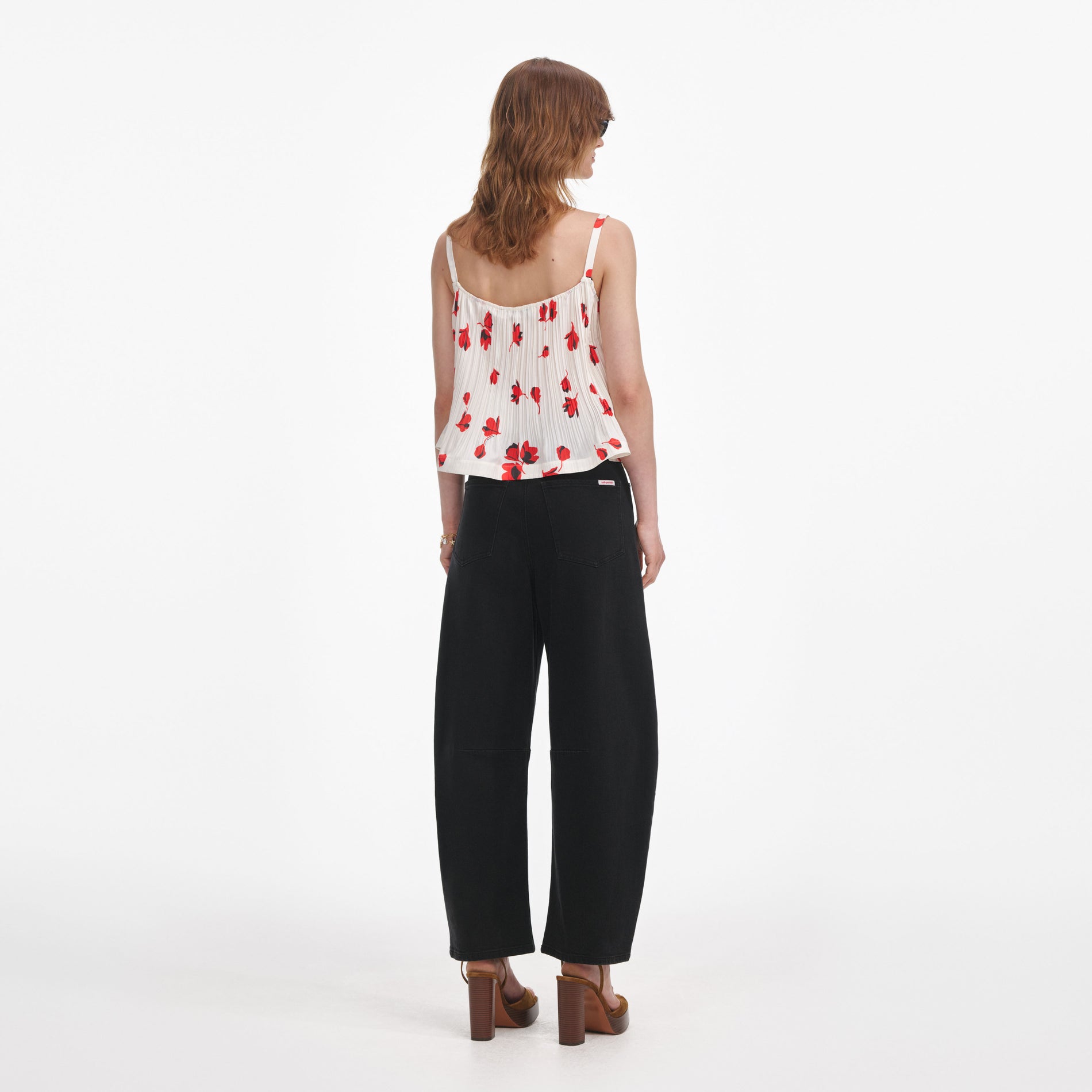 Back view of a woman wearing the White Floral Plisse  Top