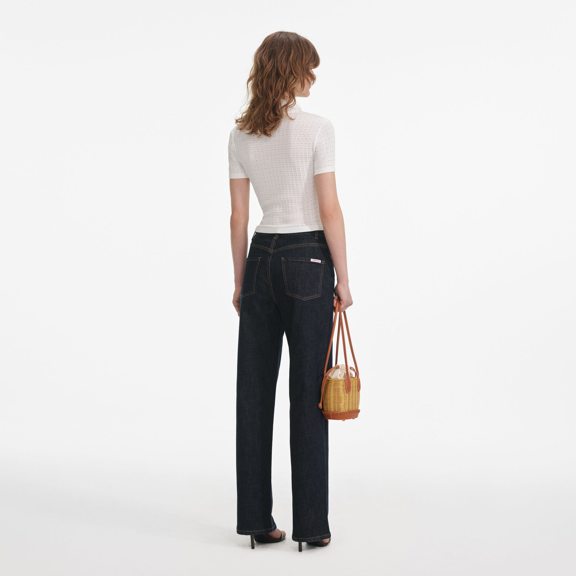 Back view of a woman wearing the White Pointelle Knit Top