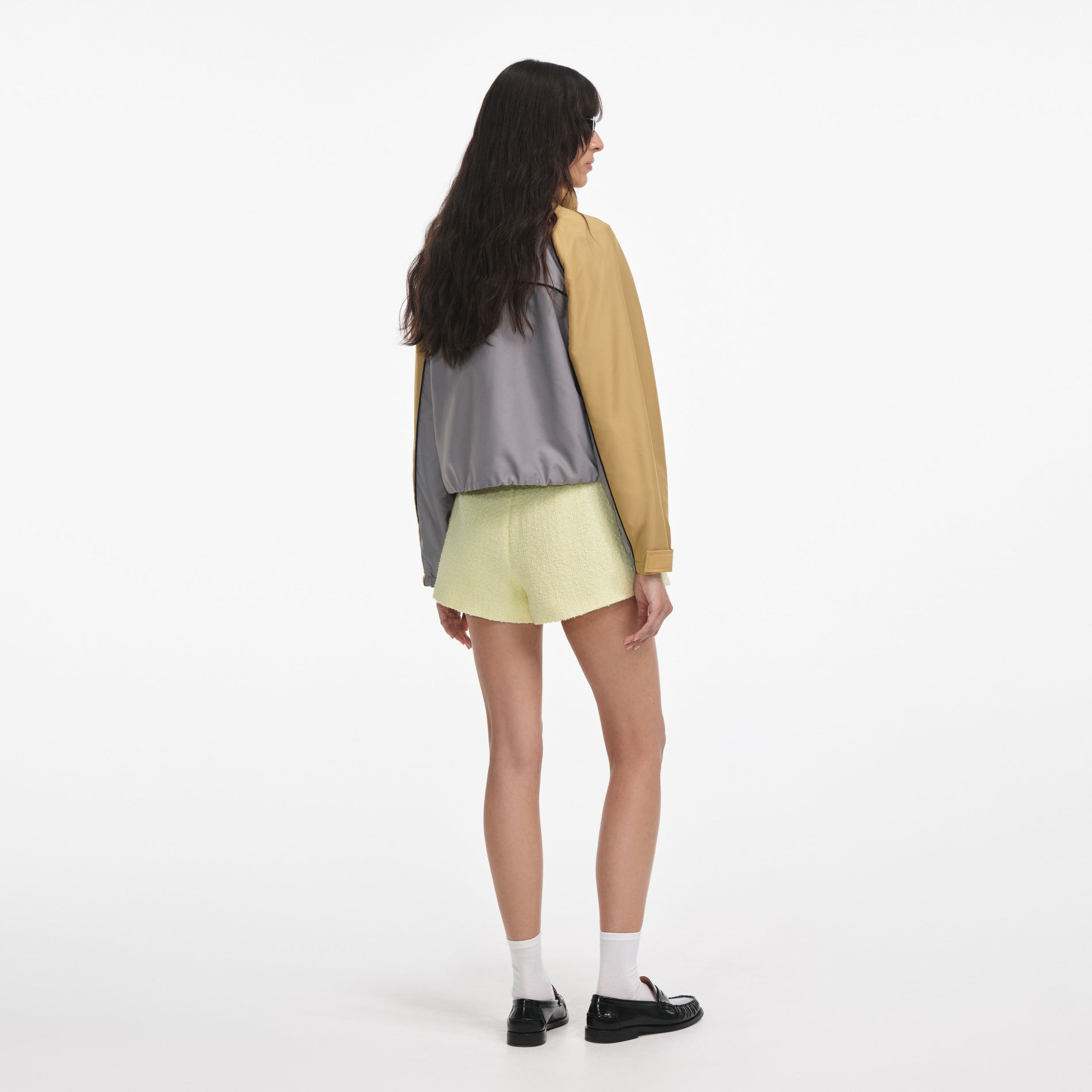 Back view of a woman wearing the Grey Nylon Cropped Windbreaker