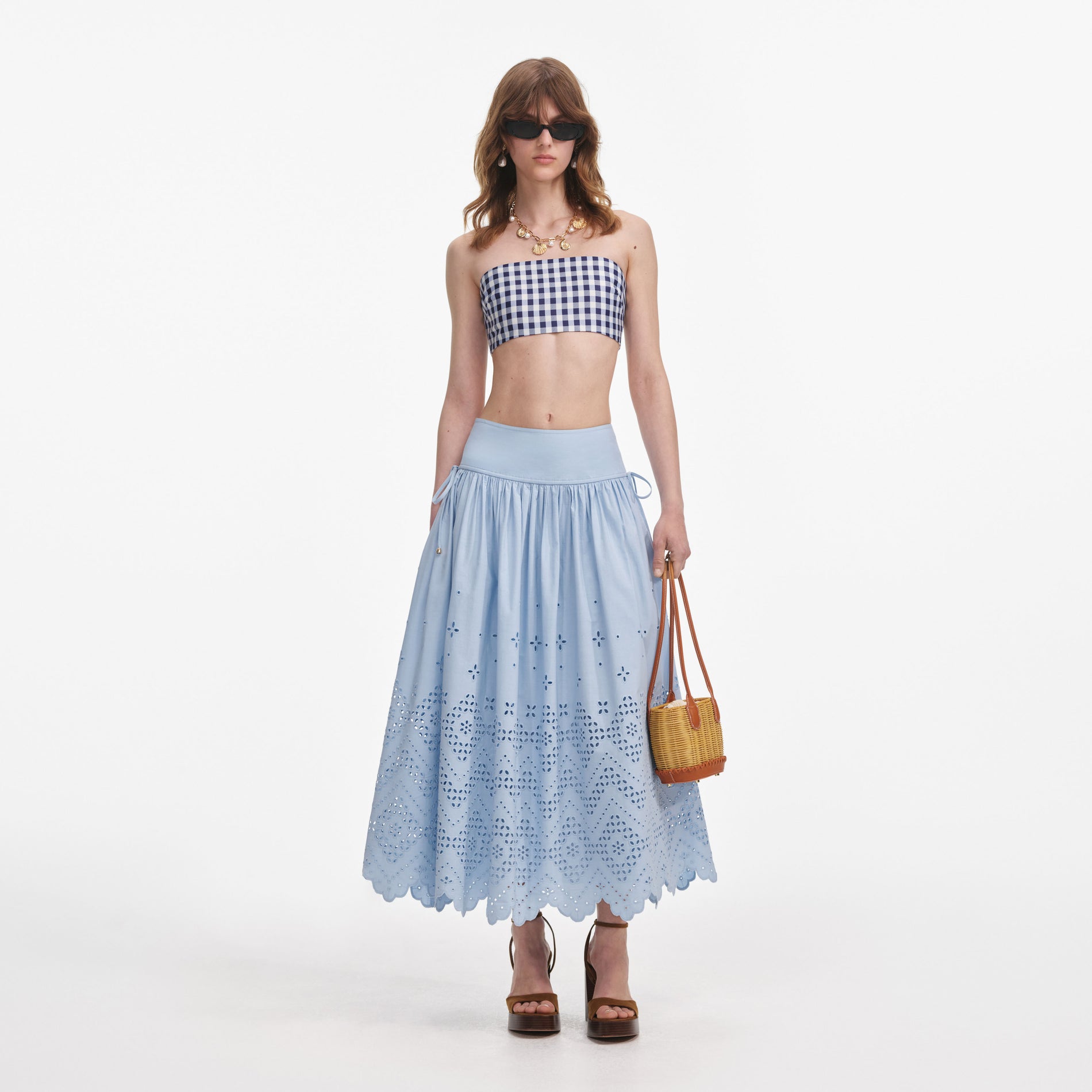Front view of a woman wearing the Blue Cotton Broderie Midi Skirt