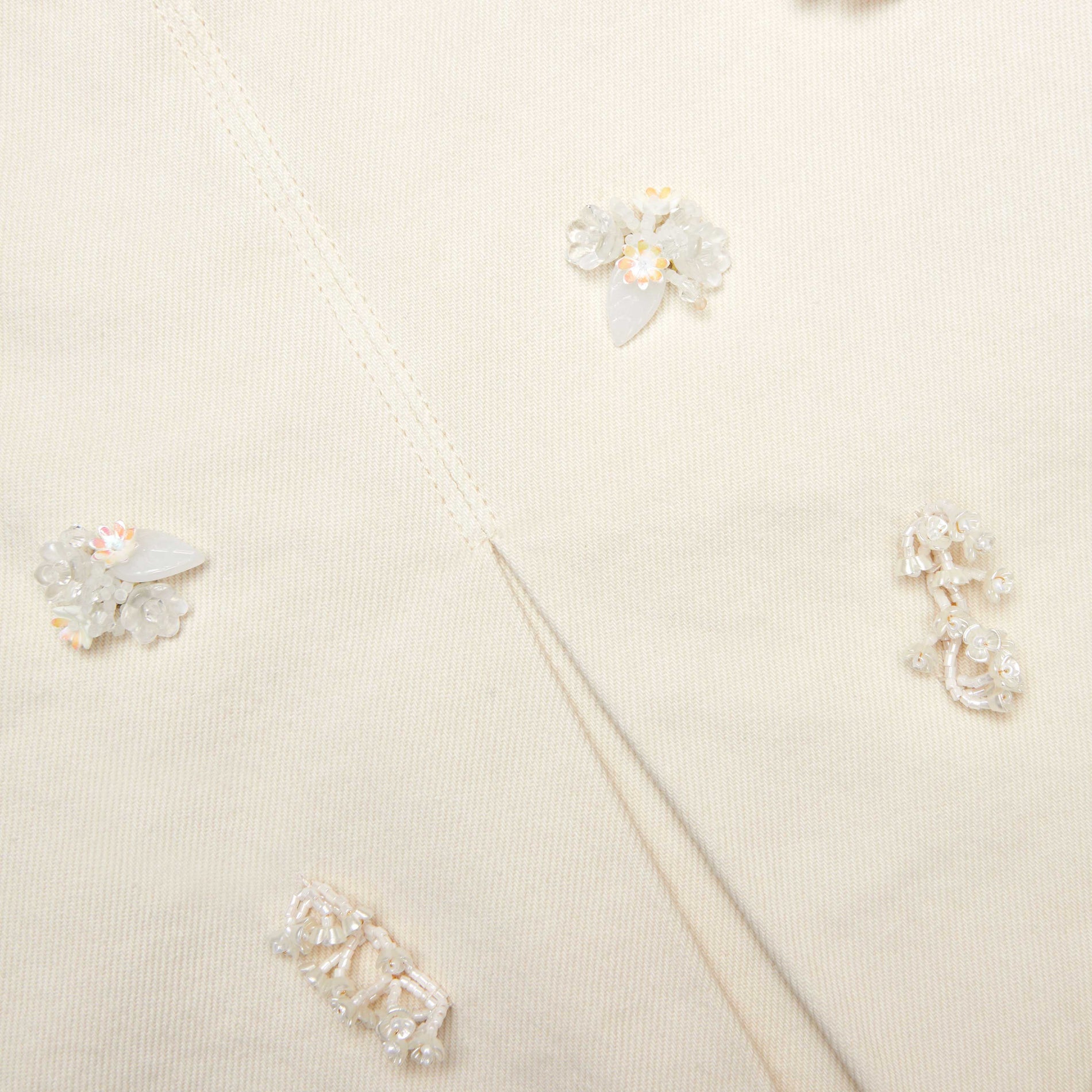 A close up of the fabric for the Cream Denim Beaded Floral Mini Skirt