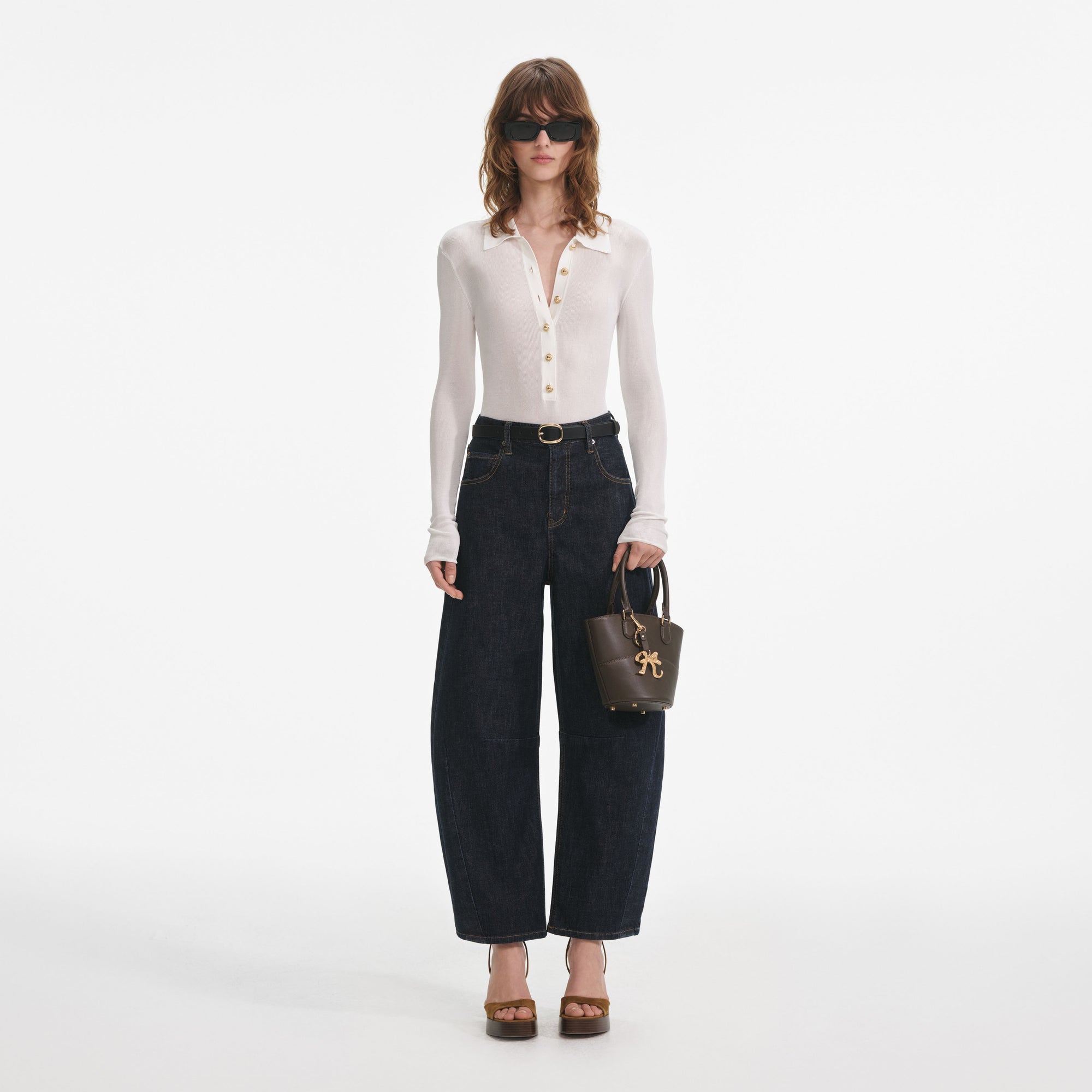 Front view of a woman wearing the Indigo Barrel Leg Jeans
