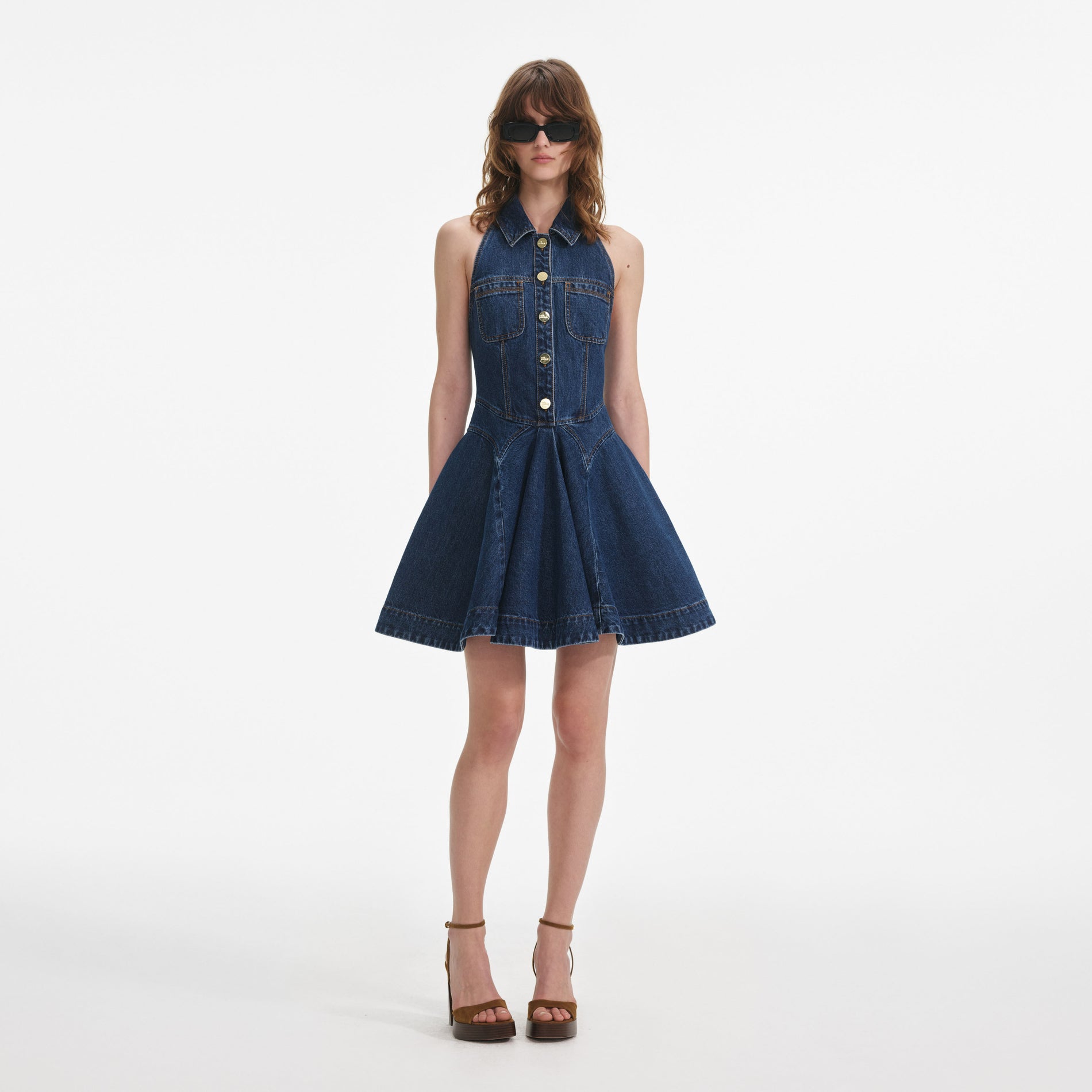 Front view of a woman wearing the Denim Sleeveless Flared Mini Dress