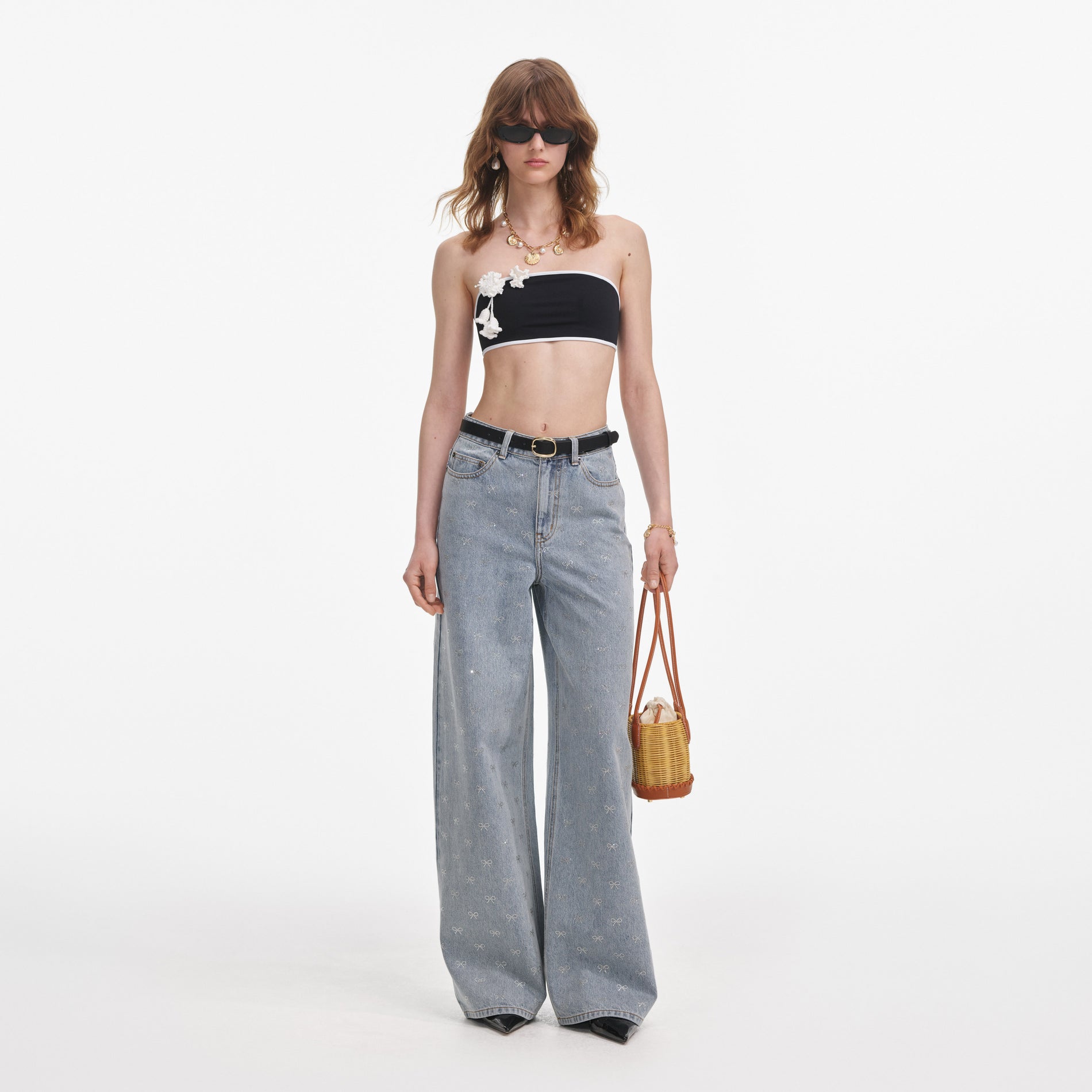 Front view of a woman wearing the Light Blue Diamante Bow Jeans