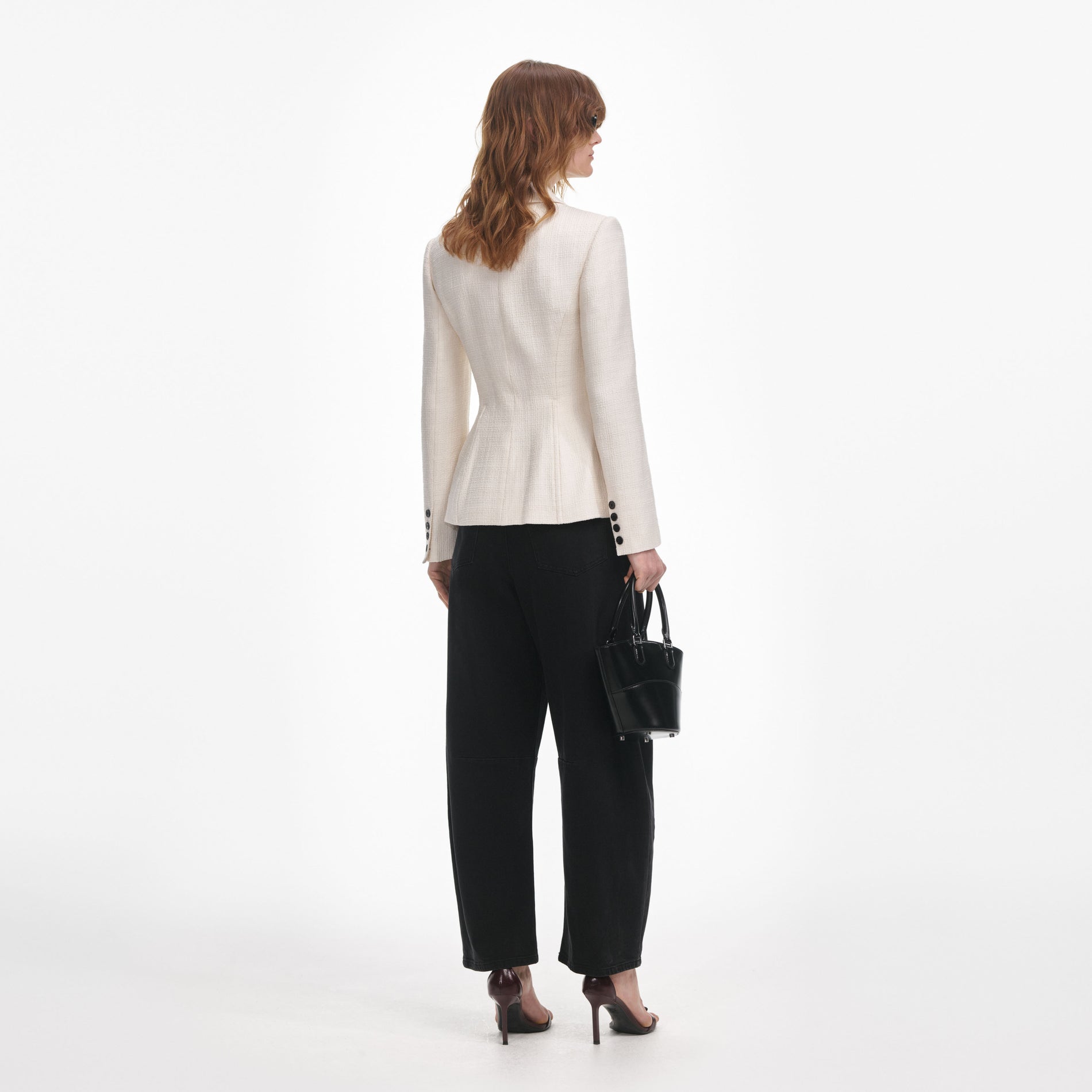 Back view of a woman wearing the Cream Boucle Jacket