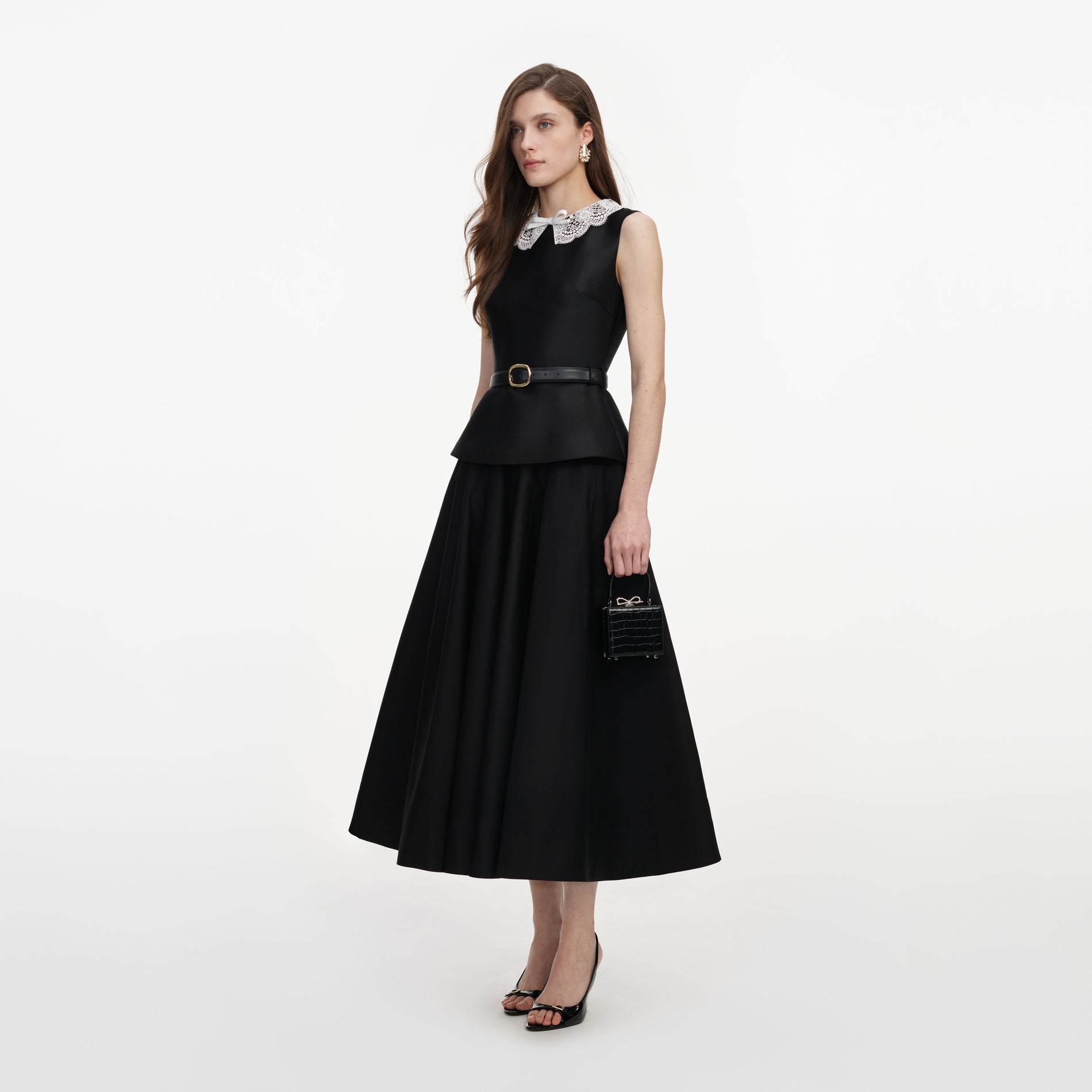 Side view of a woman wearing the Black Taffeta Peplum Midi Dress