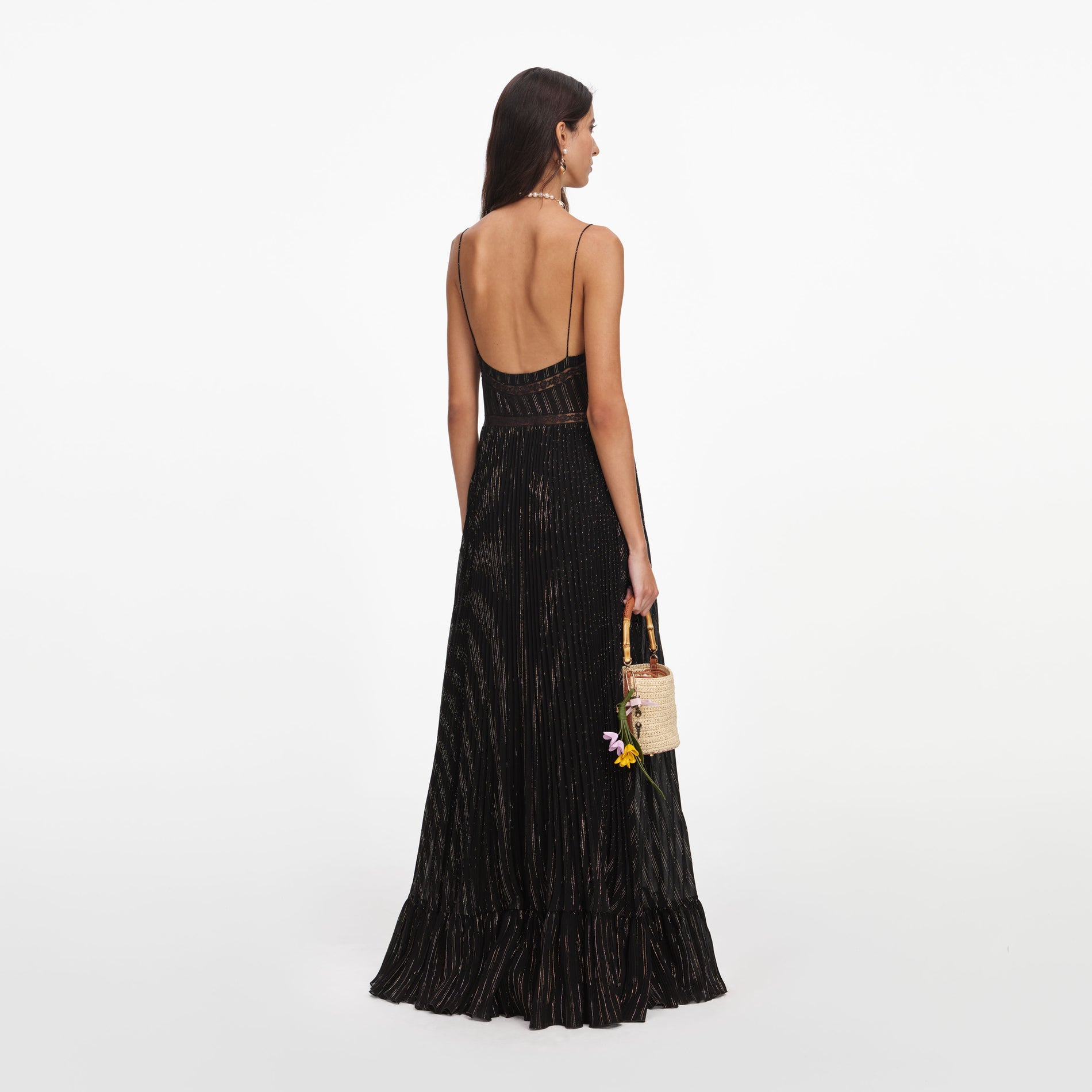 Back view of a woman wearing the Black Lurex Stripe Pleated Maxi Dress