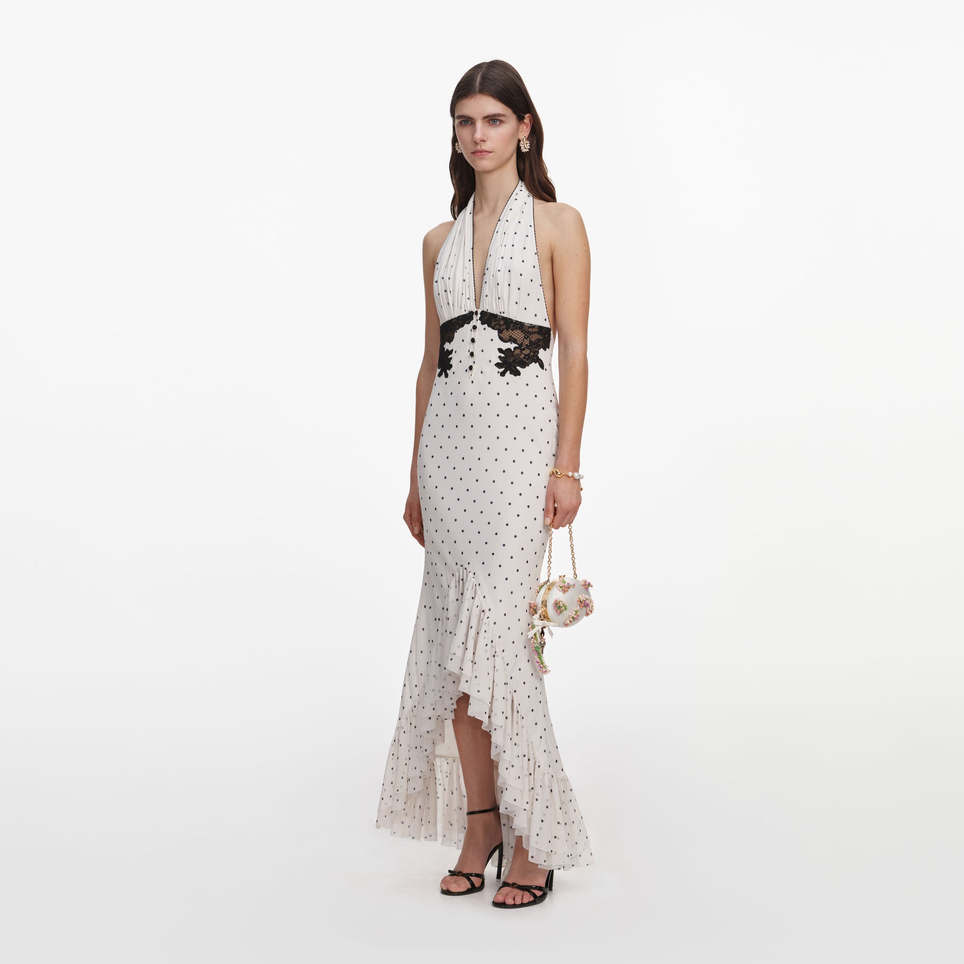 Side view of a woman wearing the Polka Dot Halter Neck Midi Dress