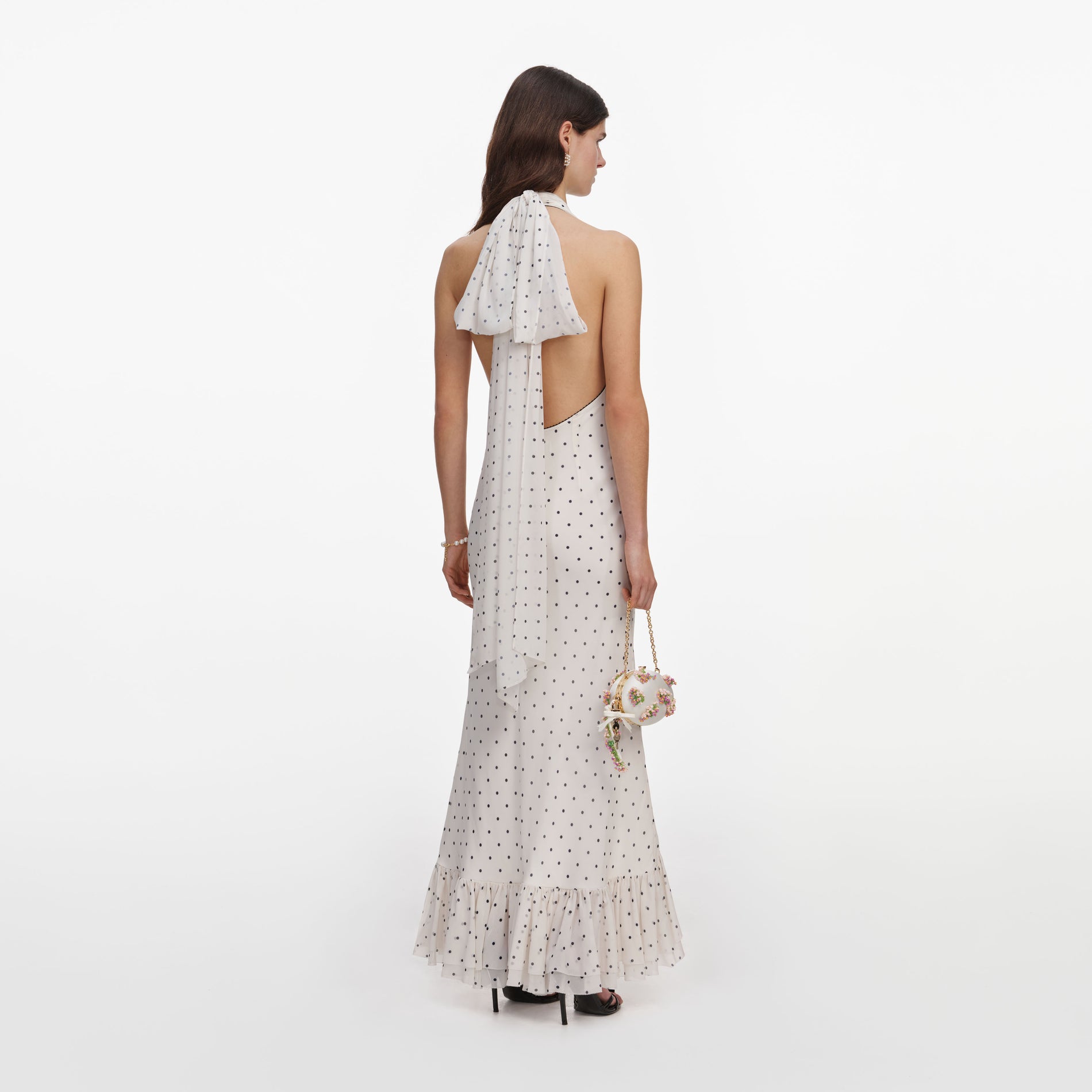 Back view of a woman wearing the Polka Dot Halter Neck Midi Dress